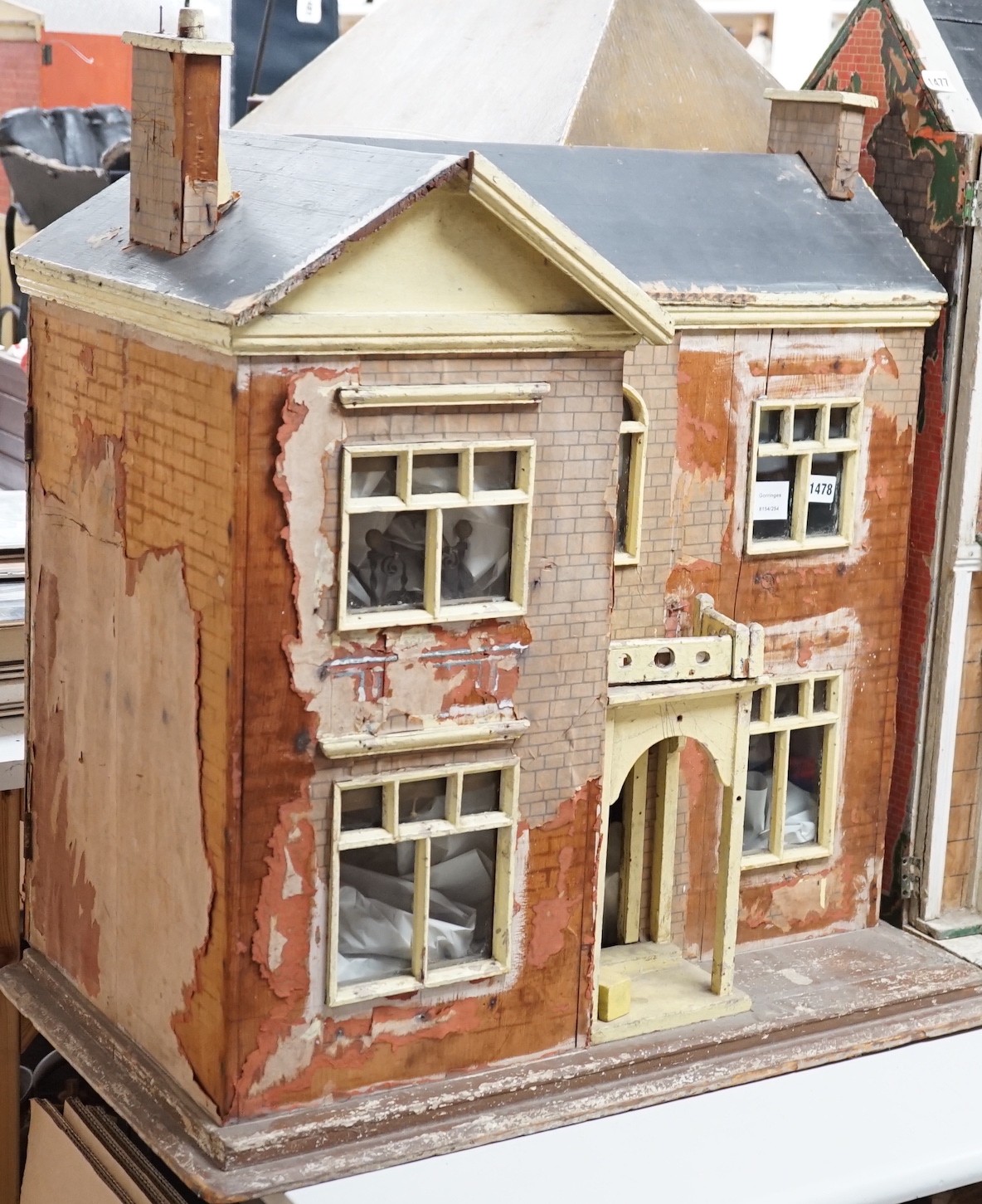 An English back-opening furnished dolls’ house, c.1900, modelled as a double-fronted brick villa, 75cms wide x 80cms high                                                                                                   