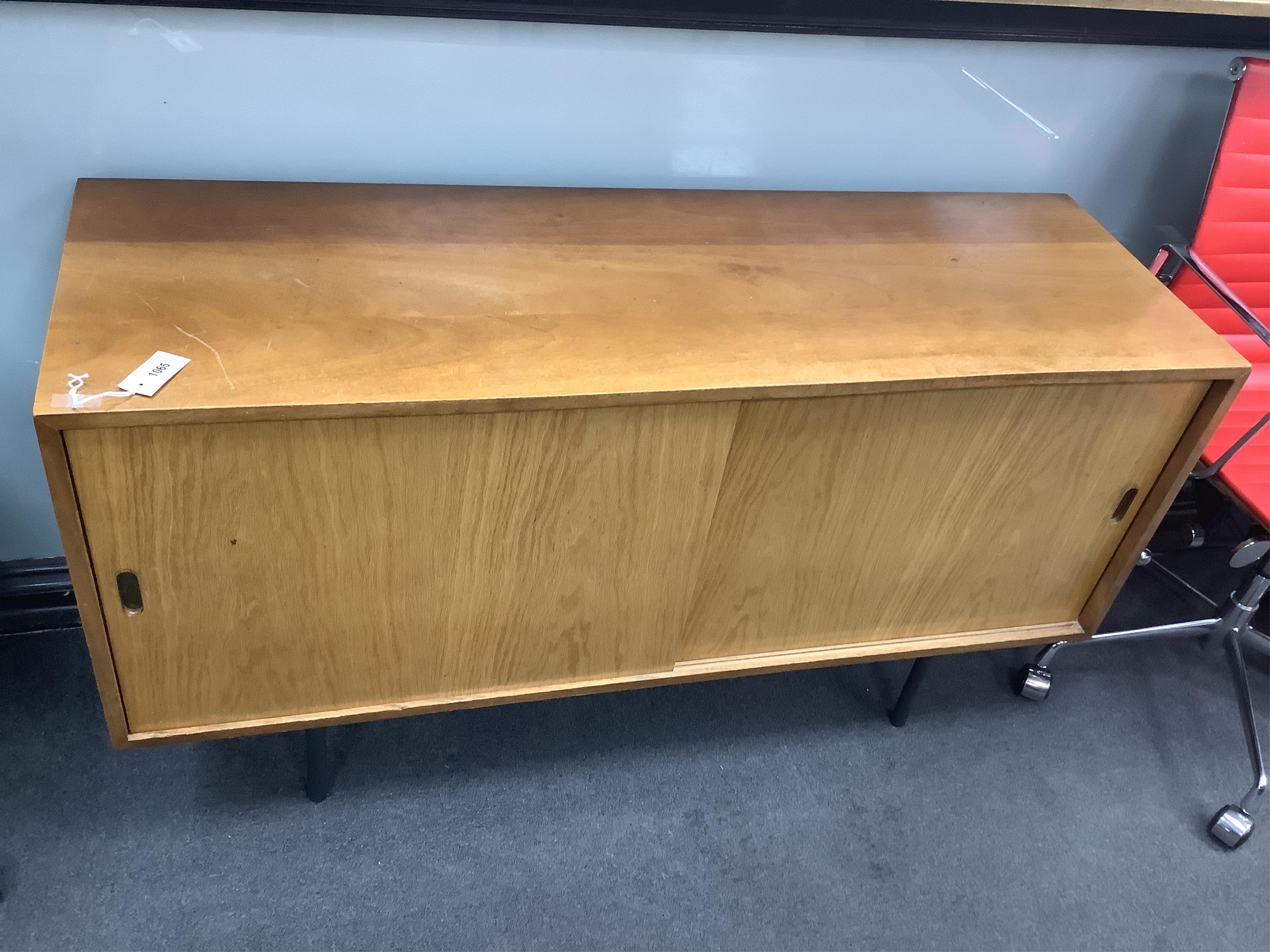 In the manner of Robin Day, a mid century walnut and plywood sideboard, width 137cm, depth 45cm, height 74cm. Condition - fair                                                                                              