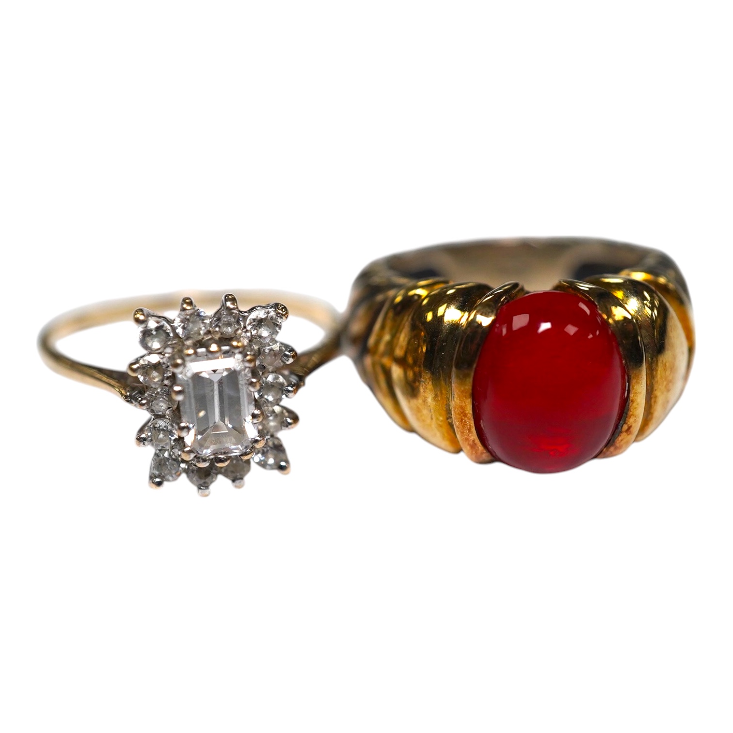 A gold and simulated diamond cluster set ring and a 14k and sterling set ring with cabochon stone. Condition - fair                                                                                                         