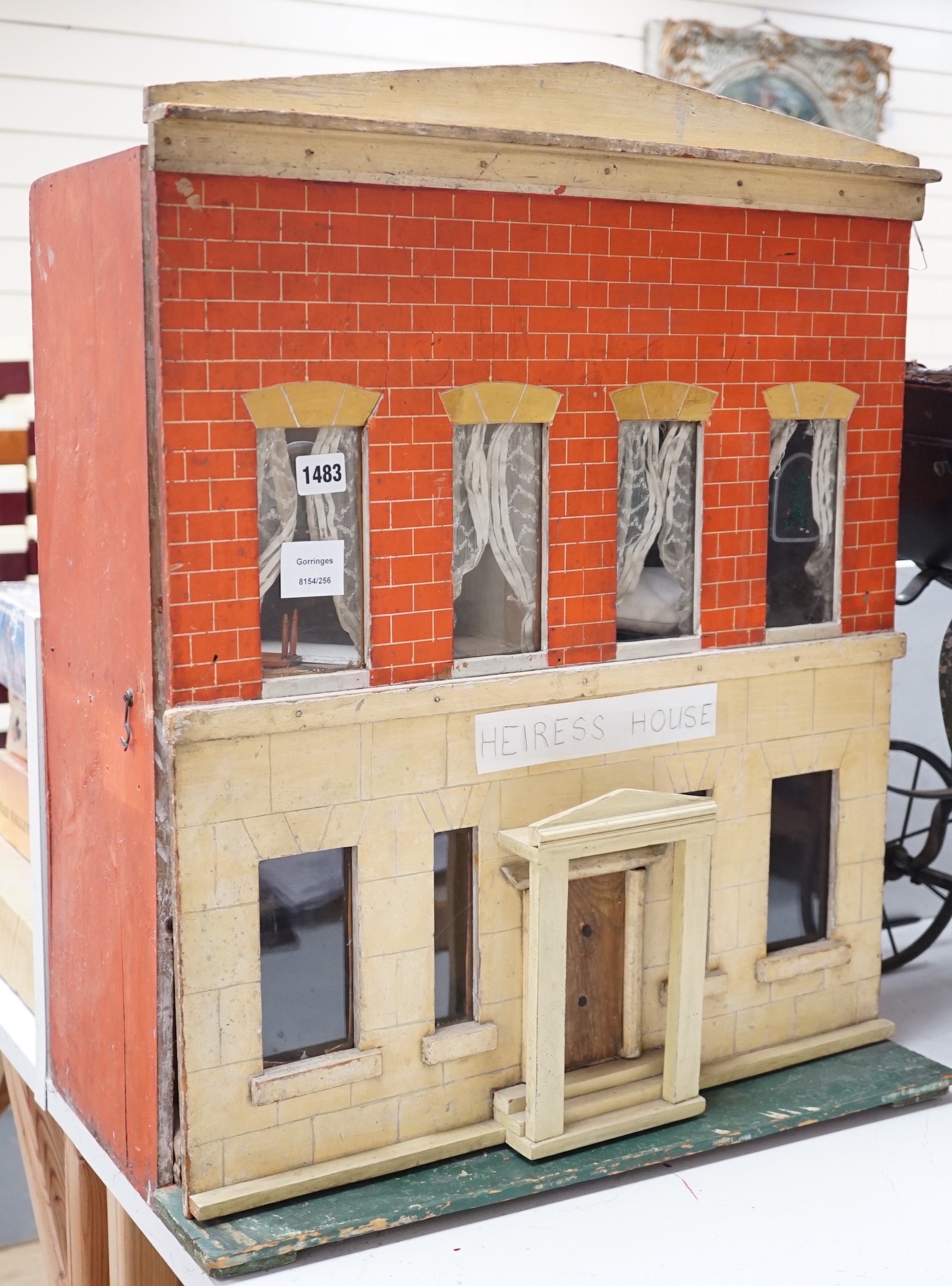 ‘Heiress House’: A commercially made London ‘boxback’ dolls’ house, late 19th century, 56cms wide x 68cms high                                                                                                              