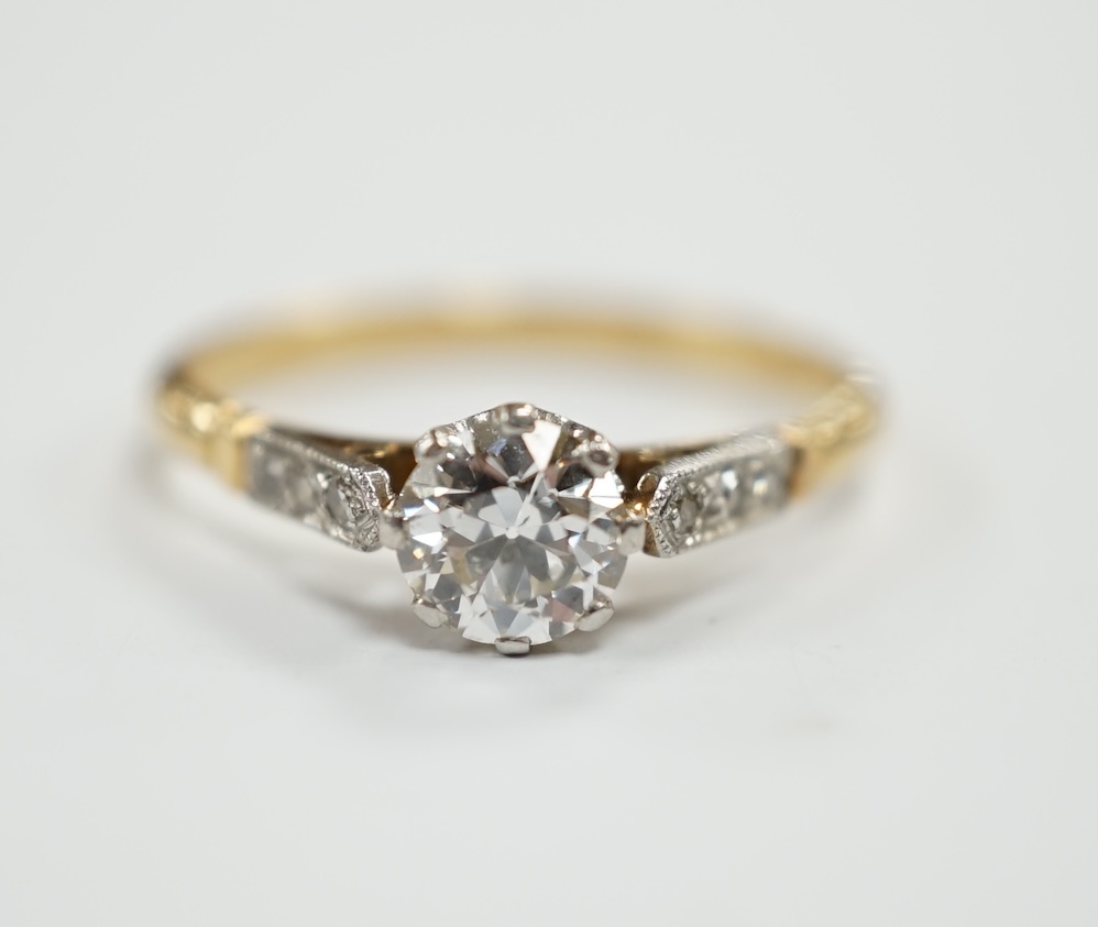 An early 20th century yellow metal and single stone diamond set ring, with diamond chip set shoulders, size N/O, gross weight 2.4 grams.                                                                                    