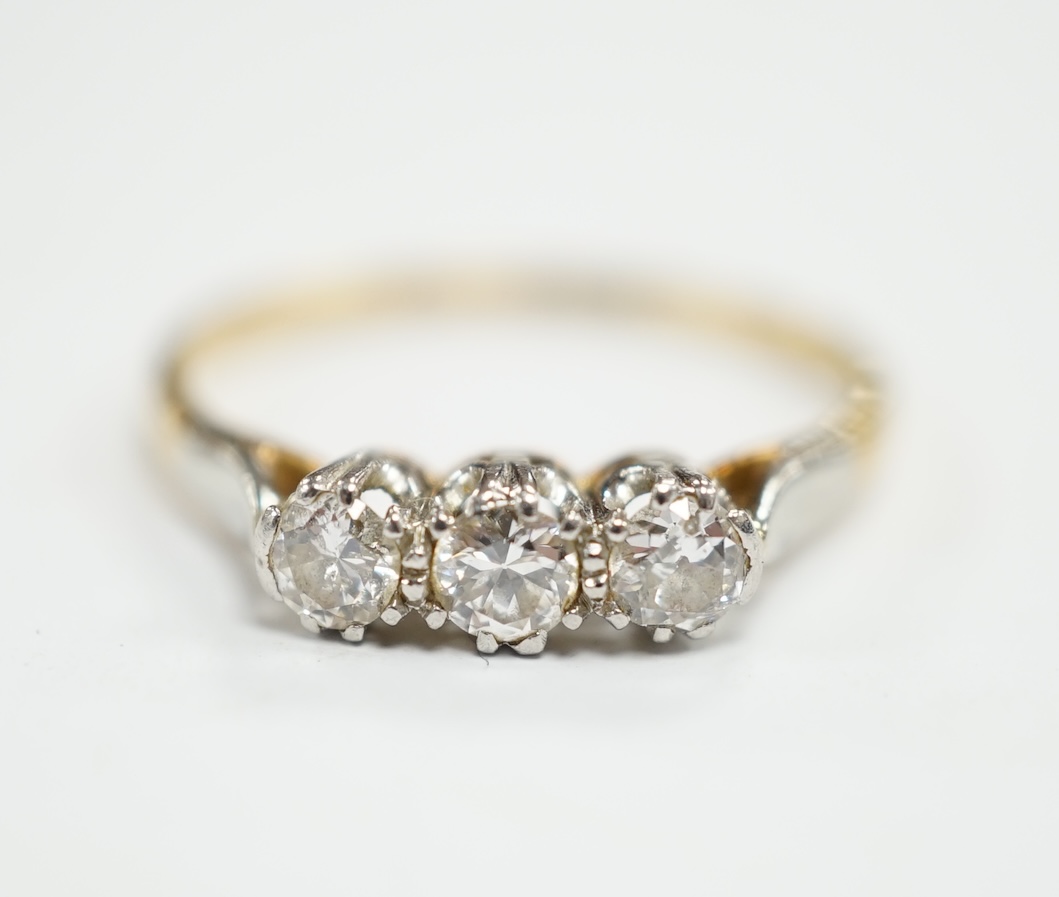 An 18ct, plat and three stone diamond set ring, size P/Q, size 2.6 grams.                                                                                                                                                   