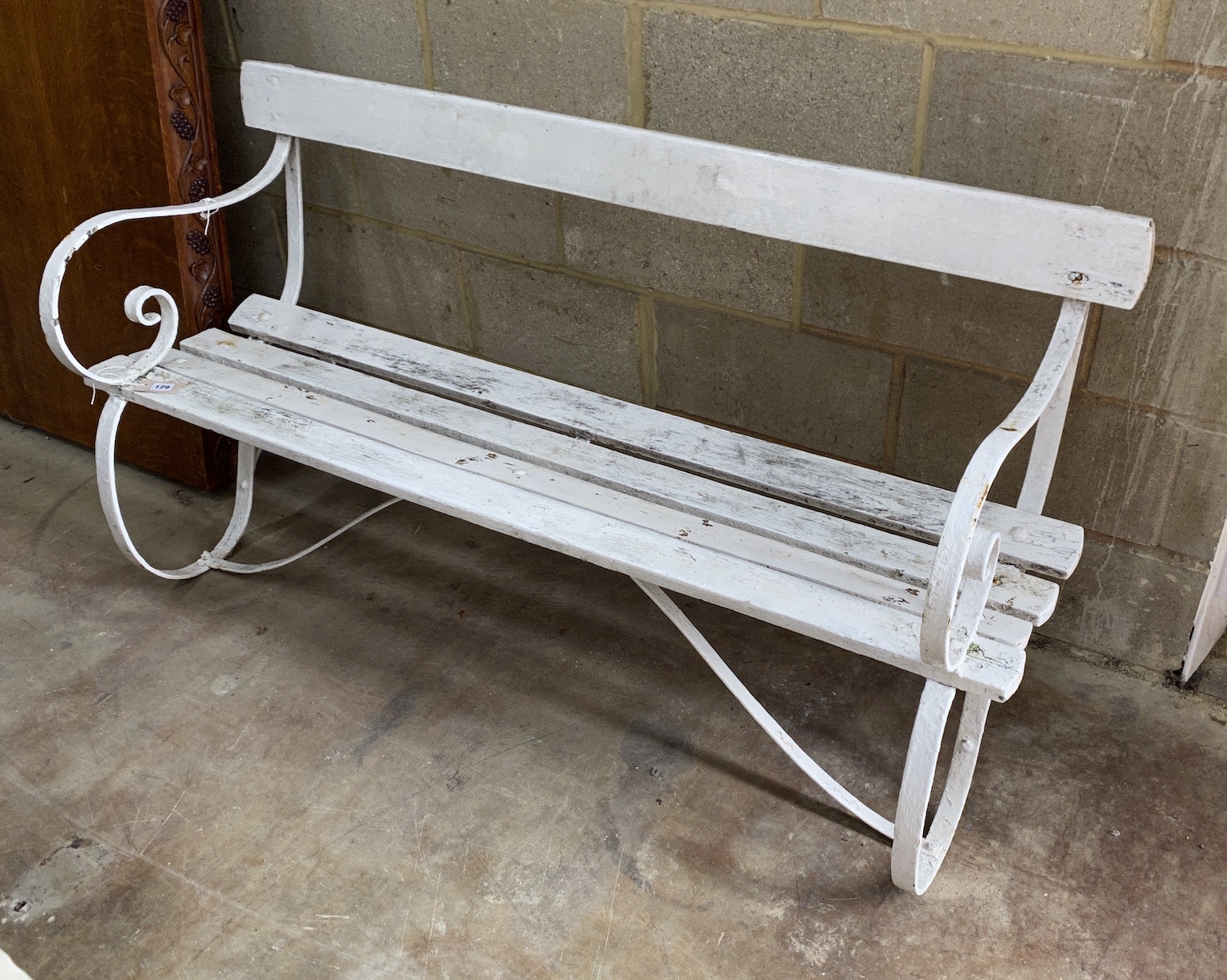 A wrought iron slatted painted wood garden bench, length 150cm, depth 64cm, height 79cm                                                                                                                                     