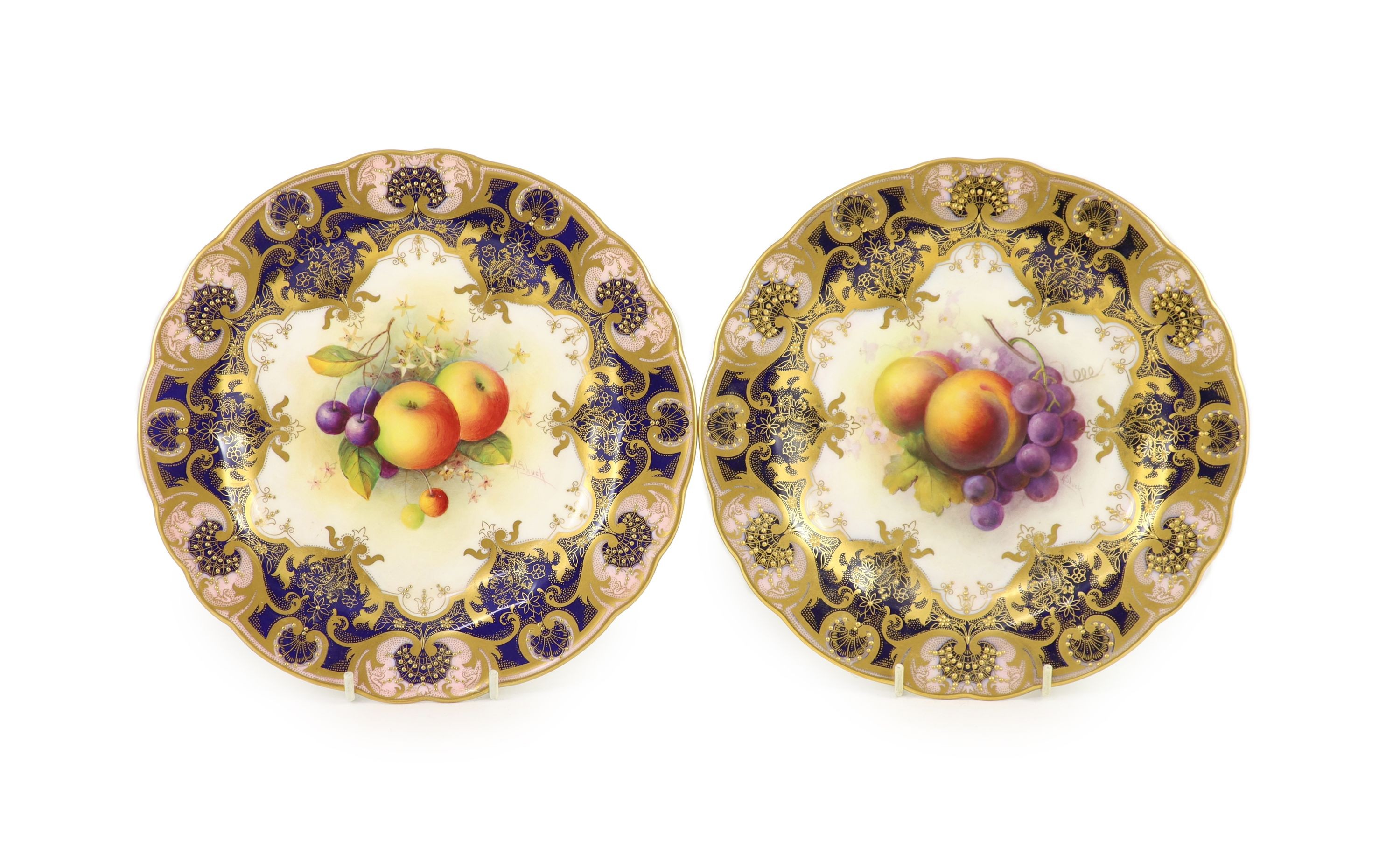 A pair of Royal Worcester fruit painted dessert plates, signed A. Shuck, c.1918 and 1935, cm diameter                                                                                                                       