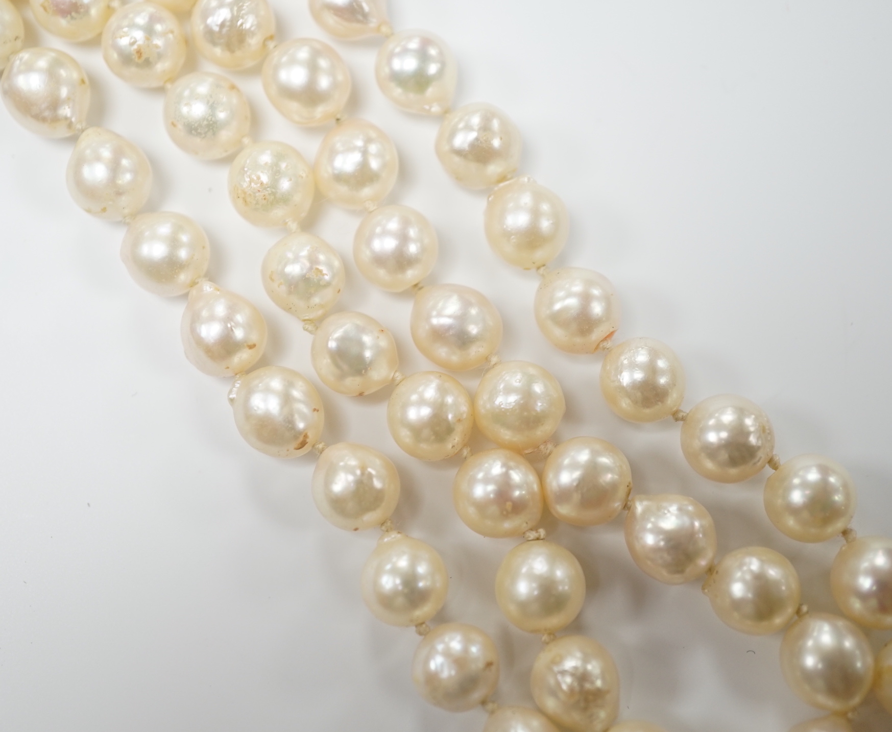A modern single strand cultured baroque pearl necklace, with 9ct and sapphire set clasp, 66cm.                                                                                                                              
