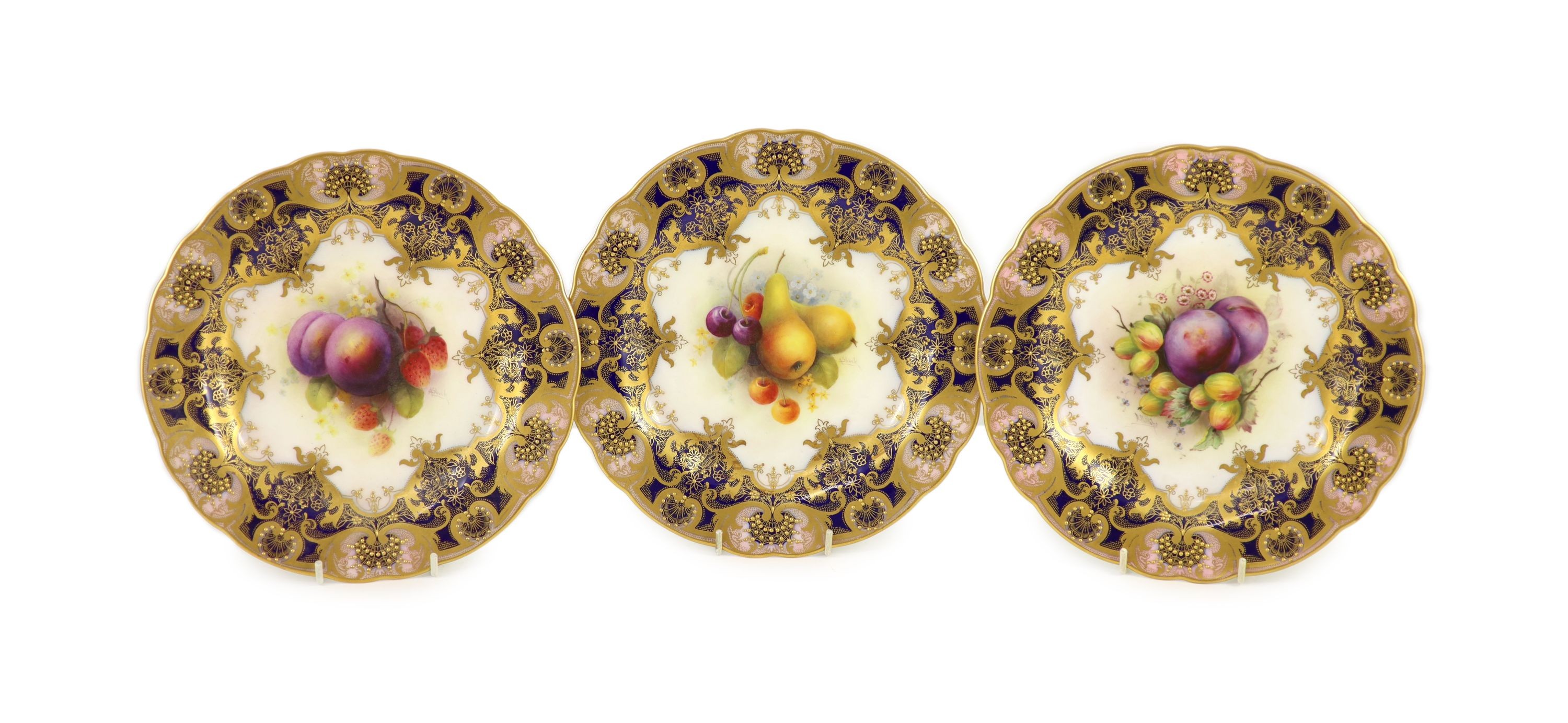 Three Royal Worcester fruit painted dessert plates, signed A. Shuck and E. Phillips, c.1918, 22.5cm diameter, two with ground off rim chip, one with tiny splinter chip                                                     