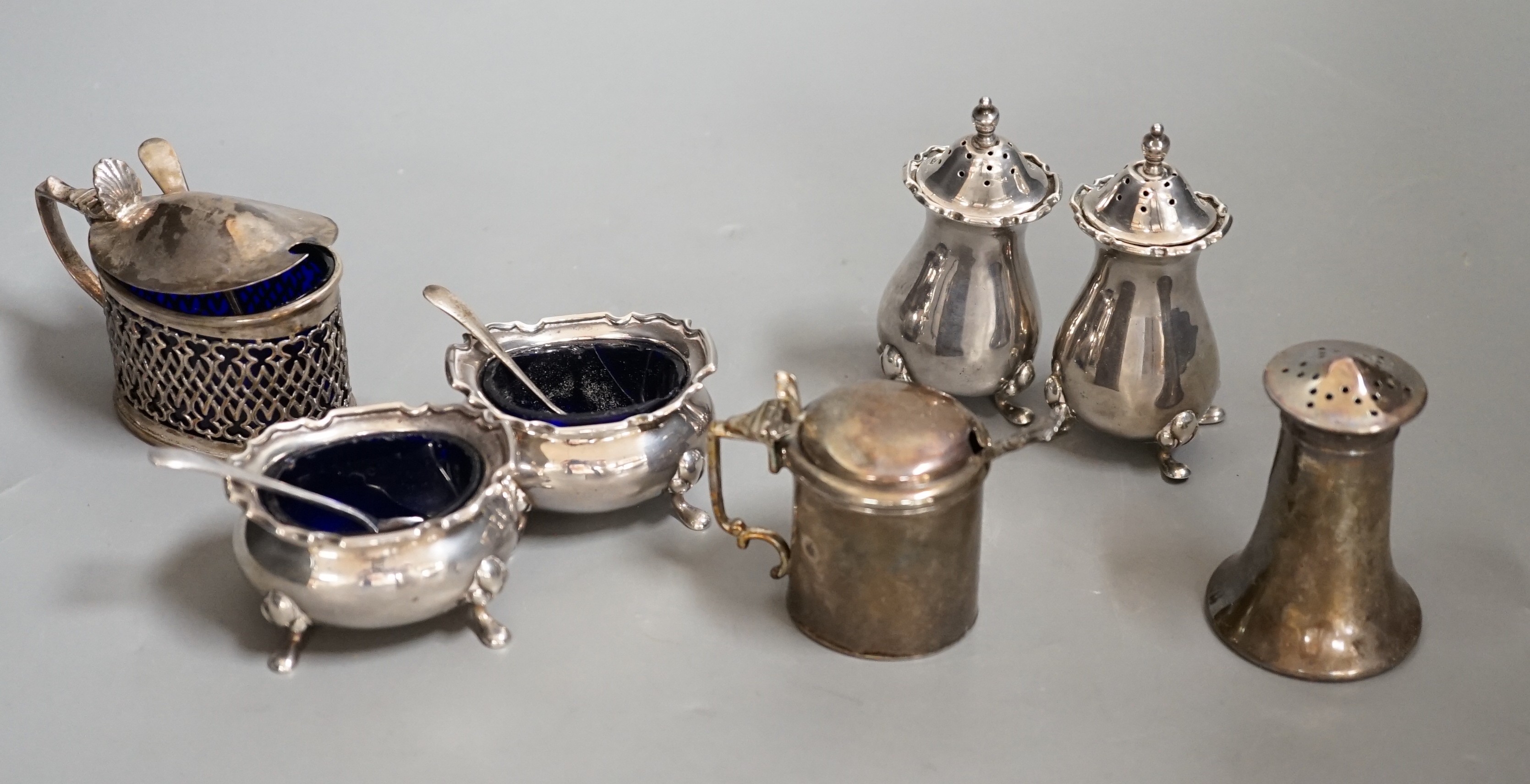 A George V silver four piece condiment set, Birmingham, 1922 and three other silver condiments.                                                                                                                             