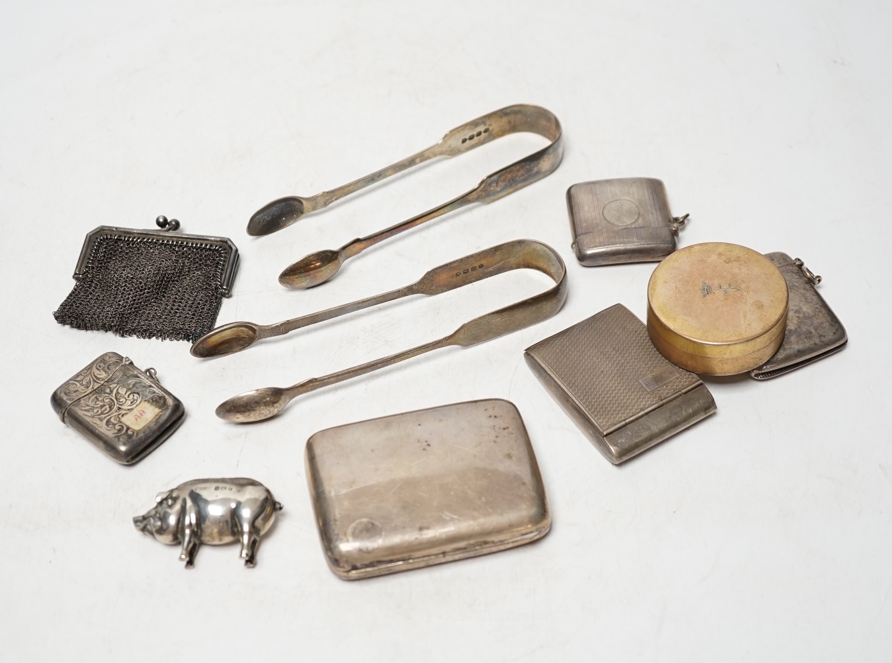 A quantity of assorted collectable silver items, including cigarette cases, vesta cases, teaspoons, fruit knives, buckles, purses, pig pin cushion, 19th century Russian caddy spoon, 800 box and cover, etc. Condition - po