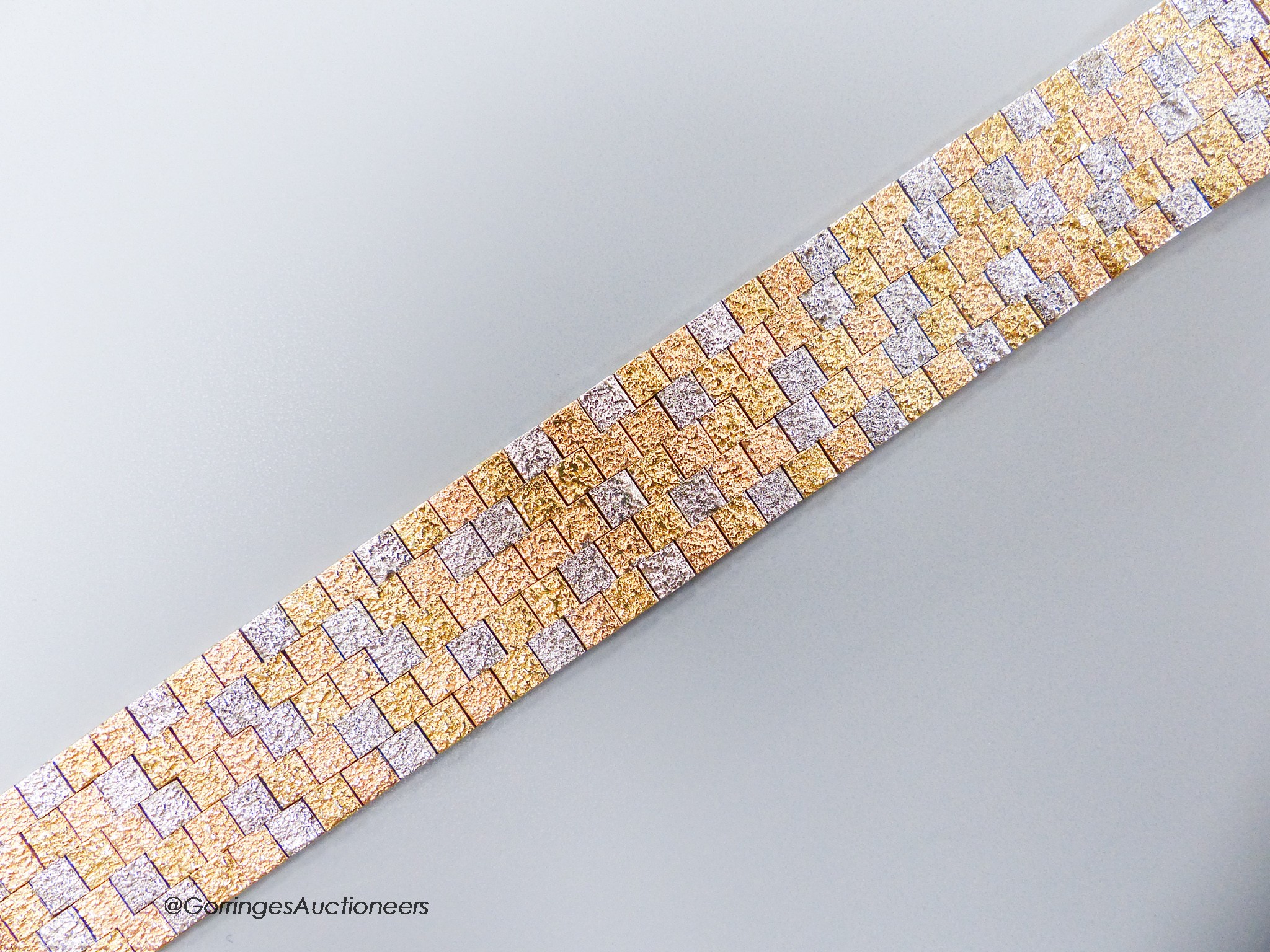 A three-colour 9ct yellow and white gold mesh bracelet, 17.7cm, 51.1 grams.                                                                                                                                                 