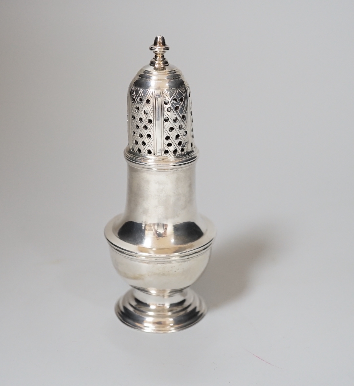 A George II silver baluster caster, makers mark obscured, London 1758, 11cm, 81 grams                                                                                                                                       