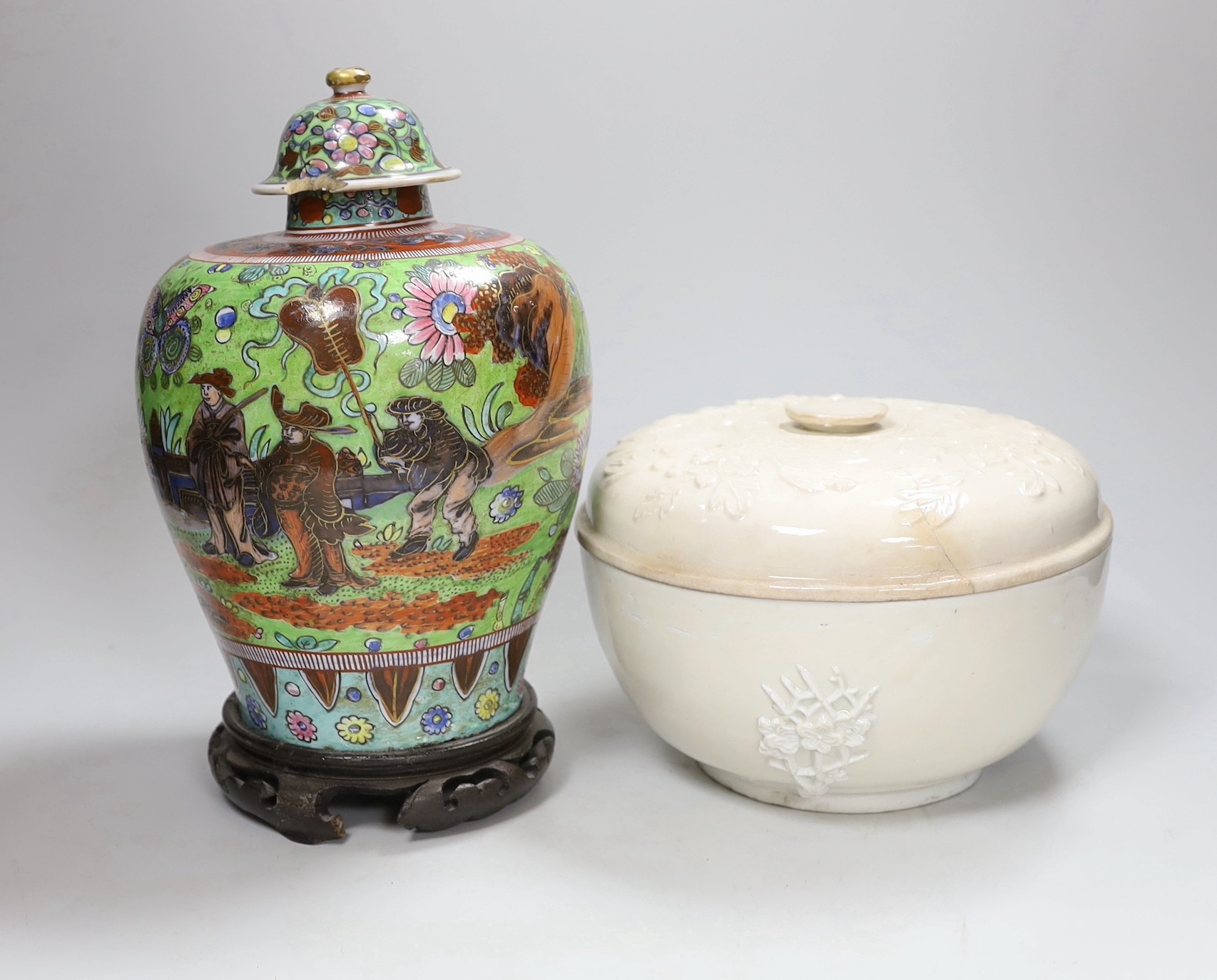 A Chinese clobbered vase and cover, and a blanc de chine bowl and cover, tallest 30cms high (2)                                                                                                                             