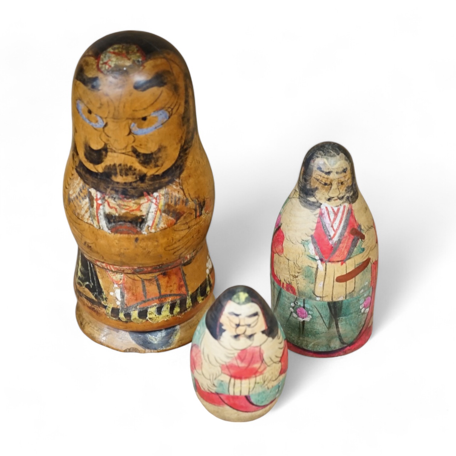 A nest of three Japanese decorated Russian dolls. Condition - fair                                                                                                                                                          