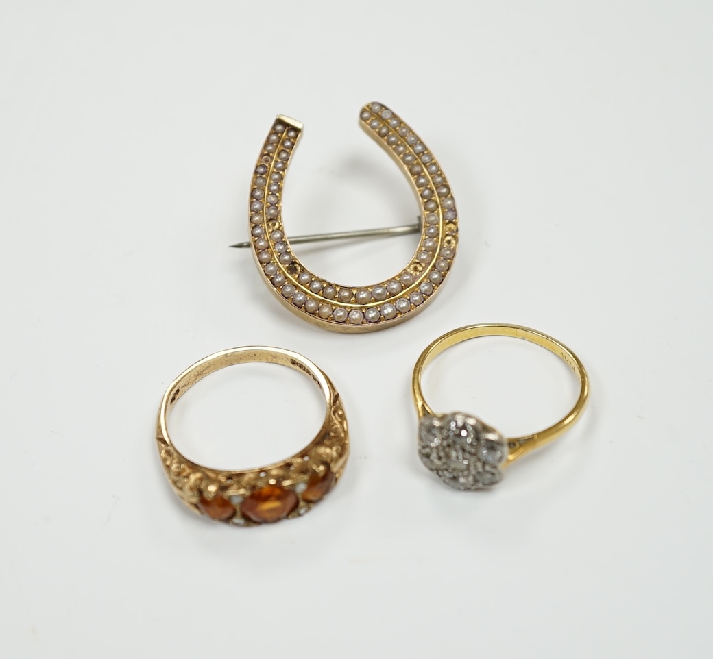 A 1920's 18ct, plat and millegrain set diamond flower head cluster ring, size L/M, a later 9ct gold and three stone citrine ring, with rose cut diamond chip spacers and a yellow metal seed pearl cluster set horseshoe bro