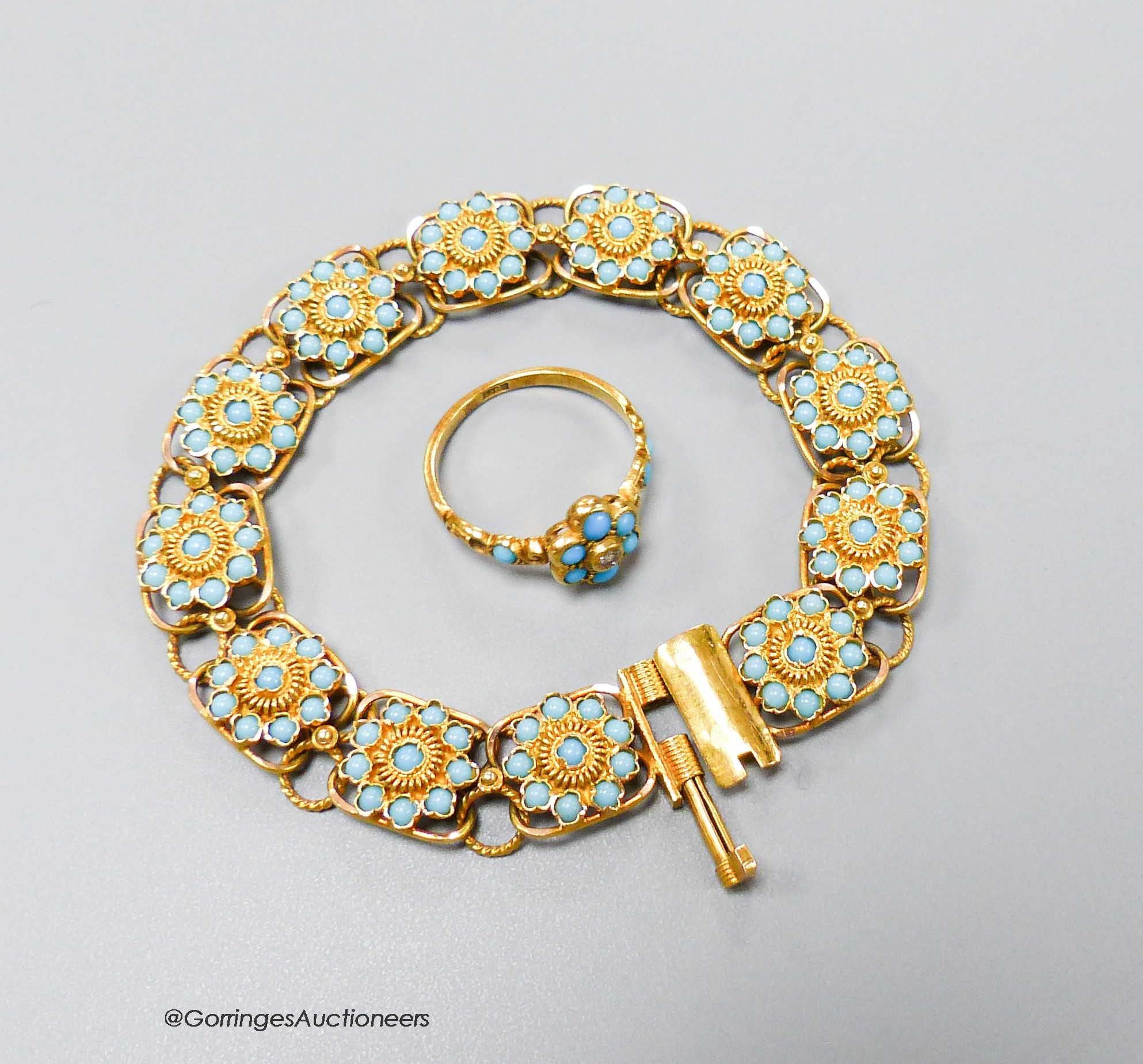 A yellow metal and blue enamel flower form twelve-cluster bracelet, 16.5cm, gross16.1 grams and an 18ct, turquoise and diamond ring, size M, gross 2.7 grams.                                                               