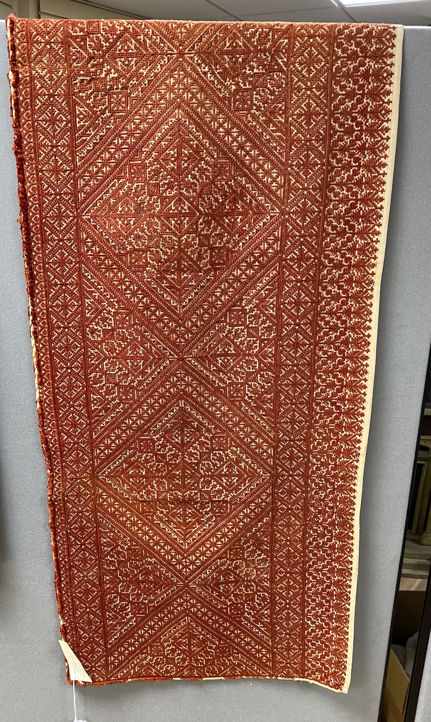 A late 19th early 20th century Fez embroidered table runner, with an all over rust silk design, 124cm wide, 44cm deep                                                                                                       