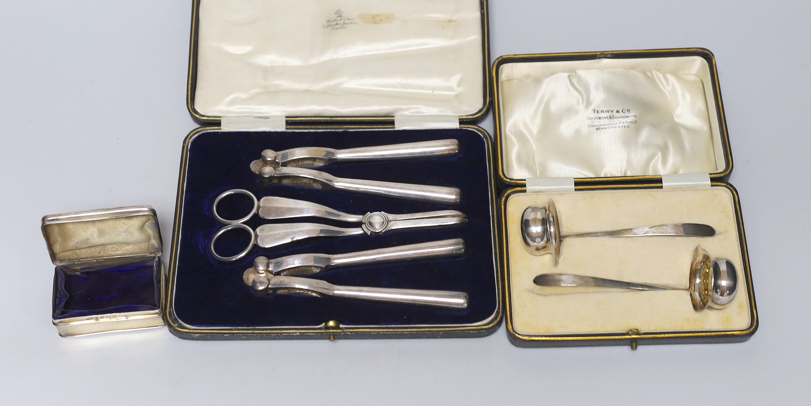 A cased pair of George V silver toddy ladles, Cooper Brothers & Sons, Sheffield, 1926, a silver trinket box and a cased plated grape shears and nutcracker set.                                                             