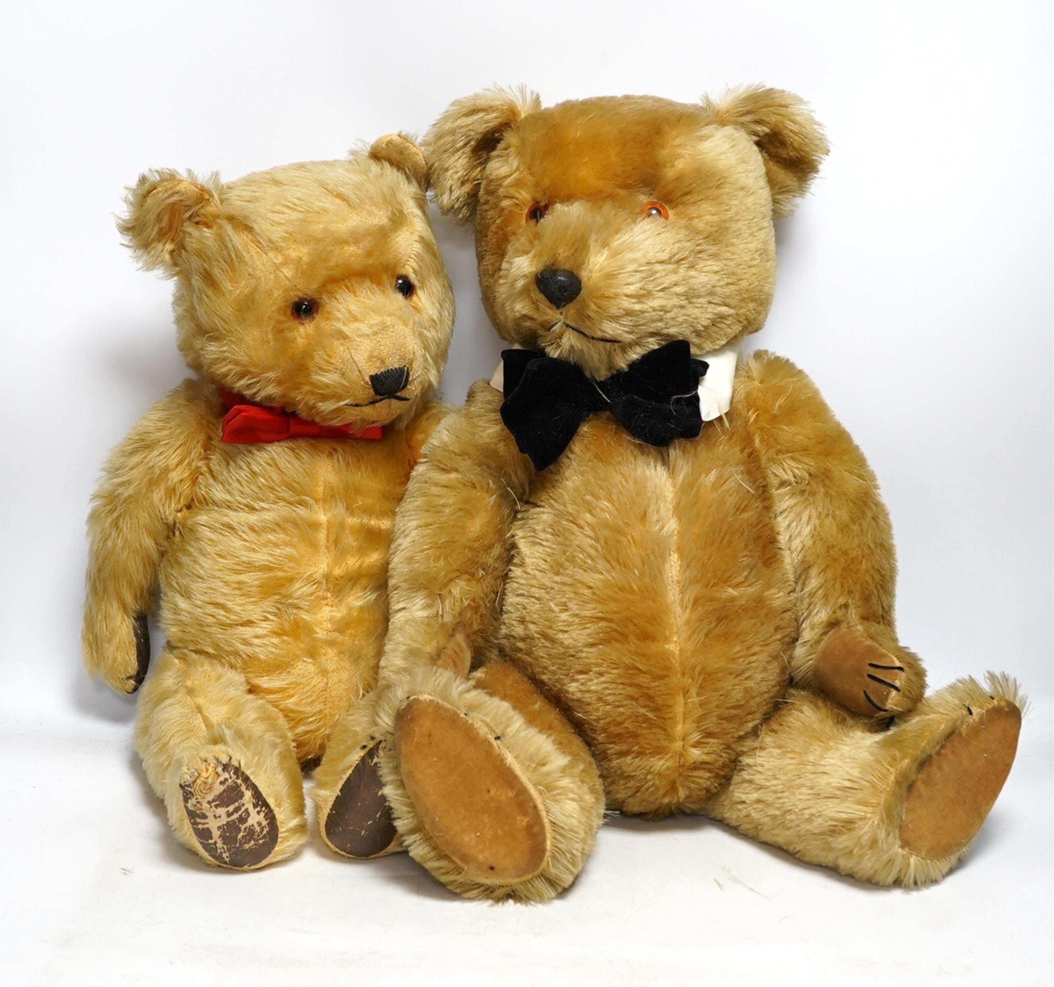 A Chiltern Hugmee teddy bear, with velvet paw pads, 59cm high, and a Chiltern Hugmee teddy bear, with oil cloth paw pads, some hair loss (2). Condition - fair                                                              