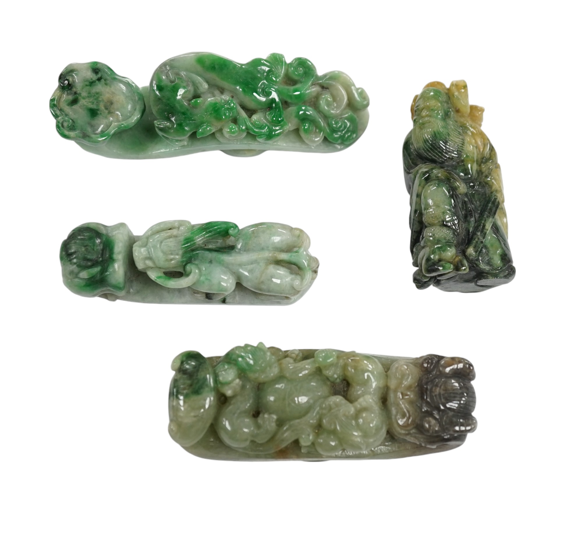 Four Chinese green bowenite jade carvings and belt hooks, largest 9.5cm in length. Condition - good                                                                                                                         