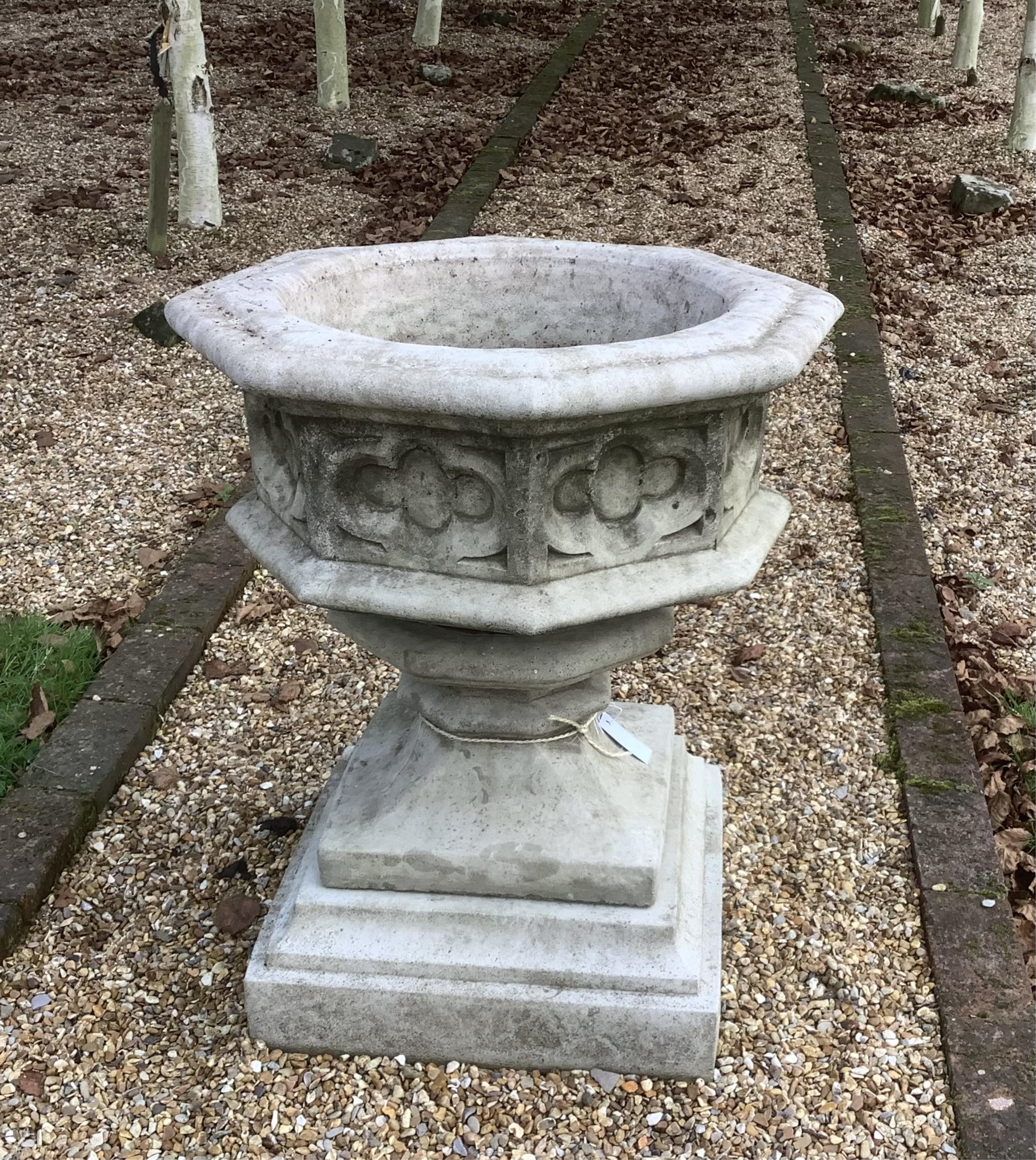 A reconstituted stone font planter, height 72cm, width 62cm. planting removed. Condition - weathered, otherwise good                                                                                                        