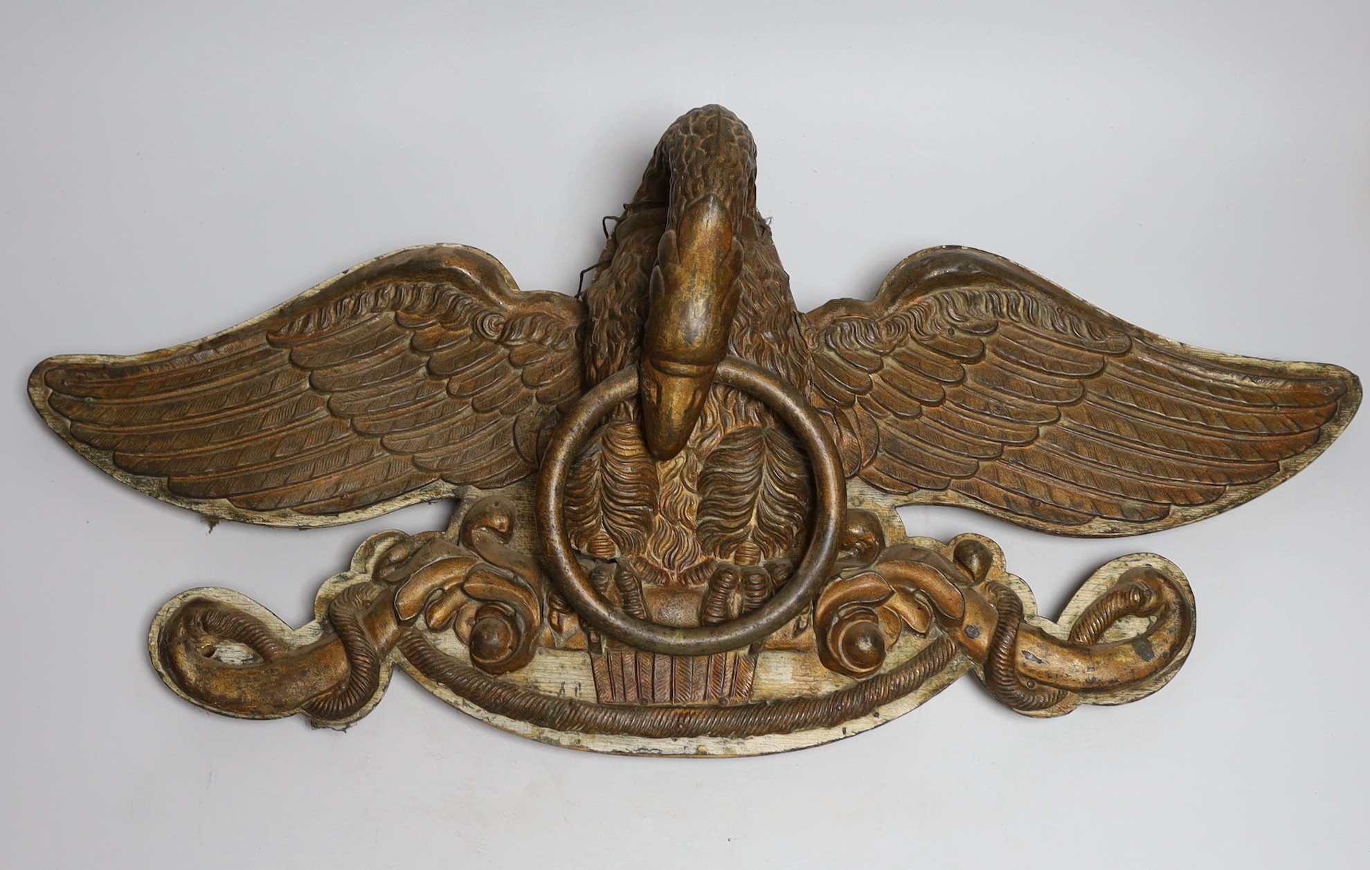 An American? painted metal eagle a on painted wooden mount, 60cms wide                                                                                                                                                      