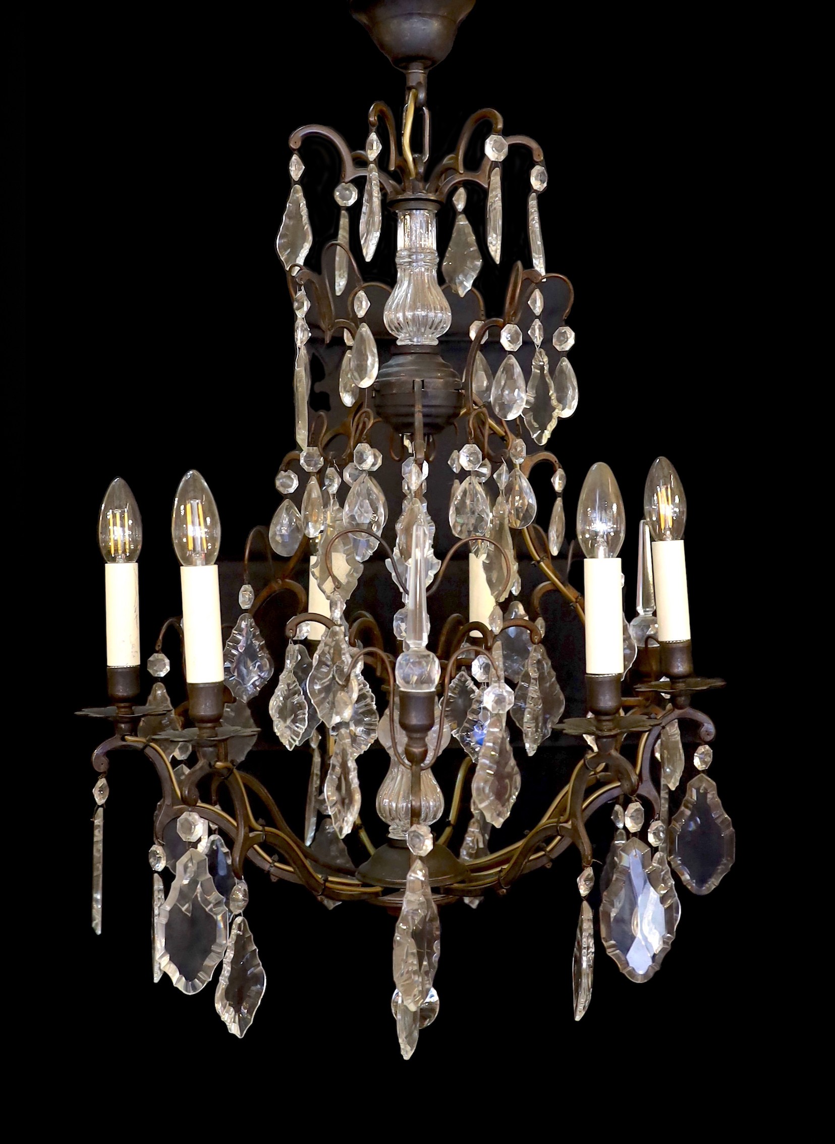 A French style patinated brass and cut glass eight light chandelier on with lozenge drops, drop 90cm. width 60cm                                                                                                            