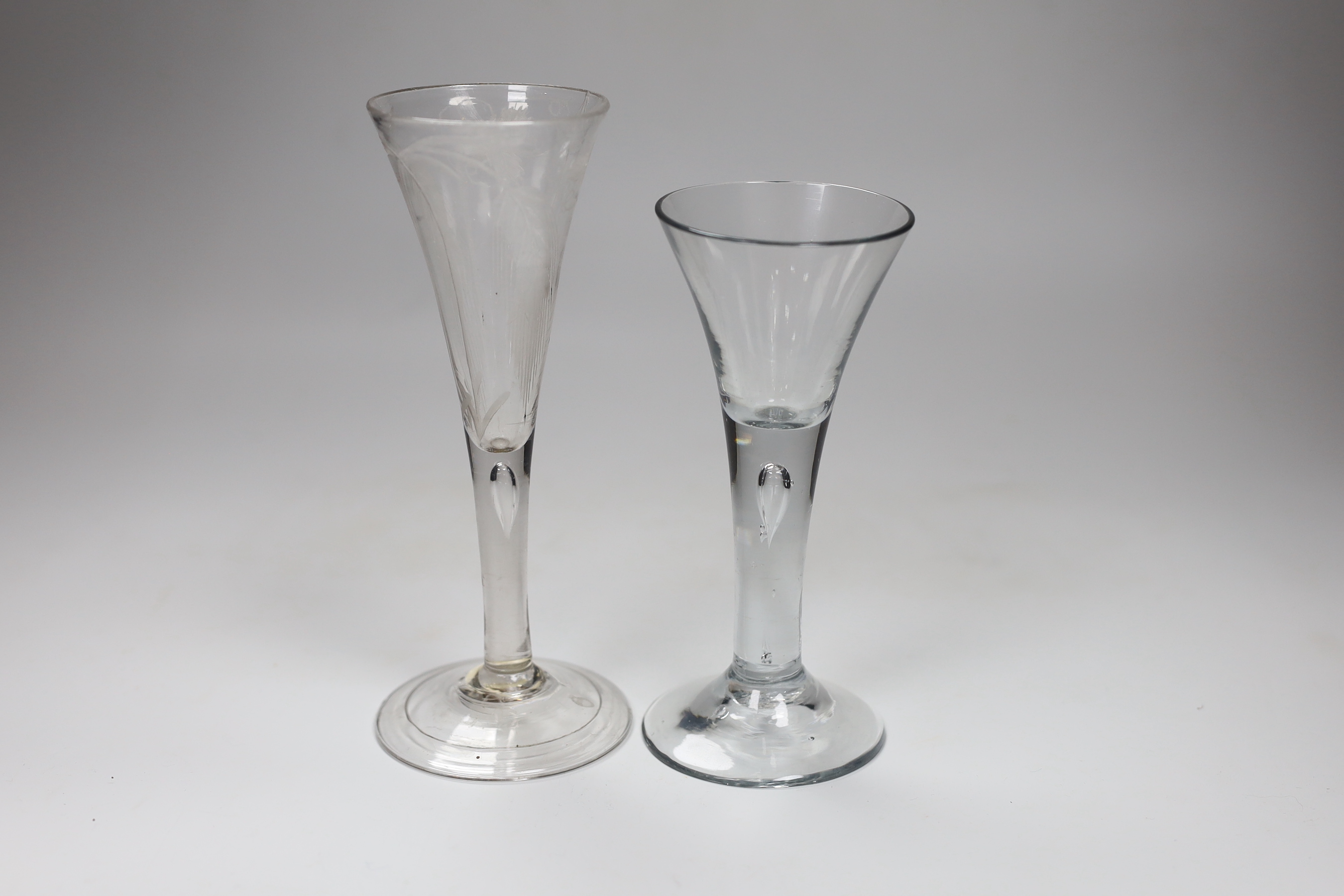 A George II engraved ale flute, and a George II ‘drawn trumpet’ wine glass, tallest 19cm                                                                                                                                    