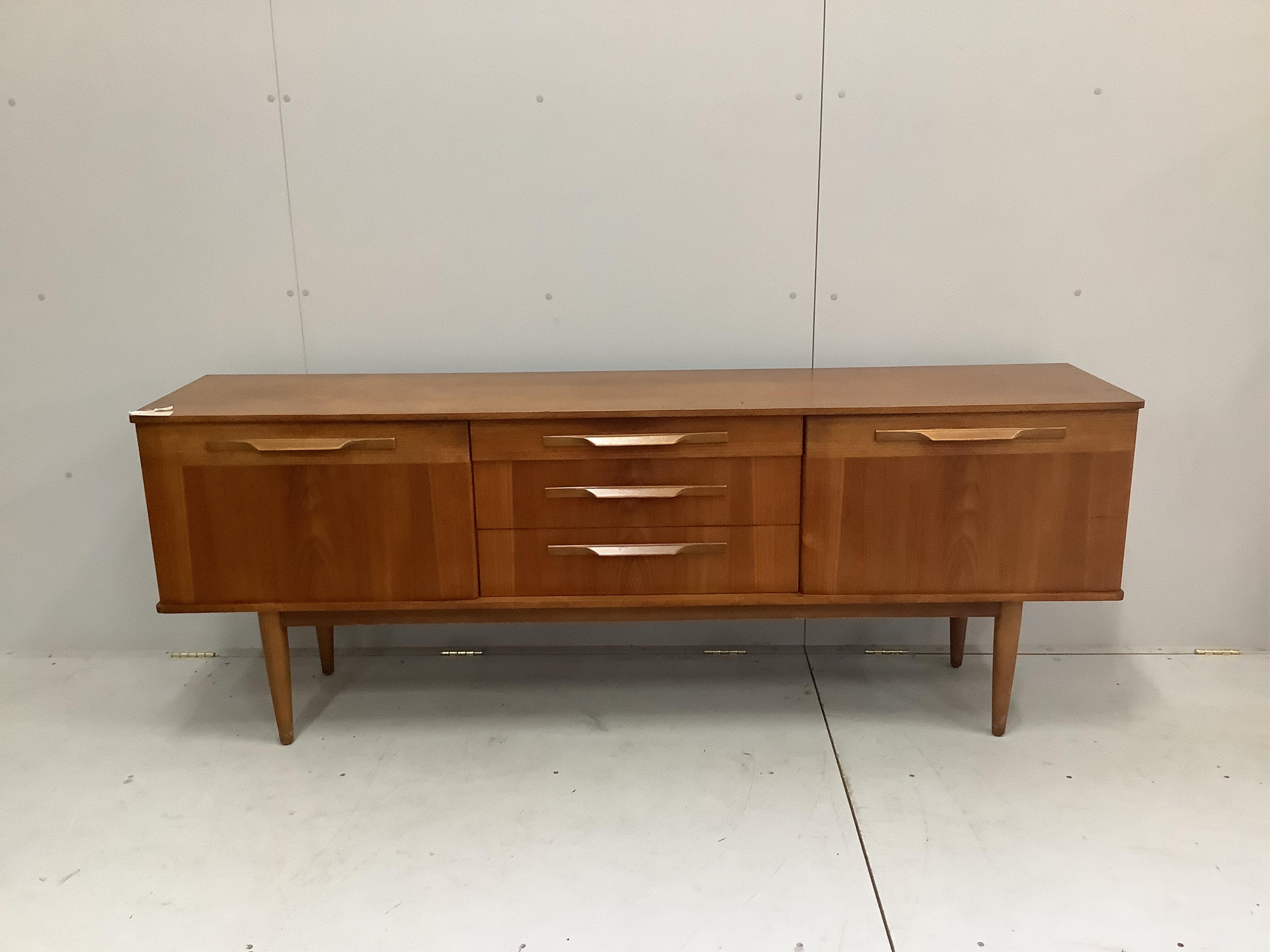 A mid century teak sideboard, width 198cm, depth 43cm, height 73cm. Condition - fair                                                                                                                                        