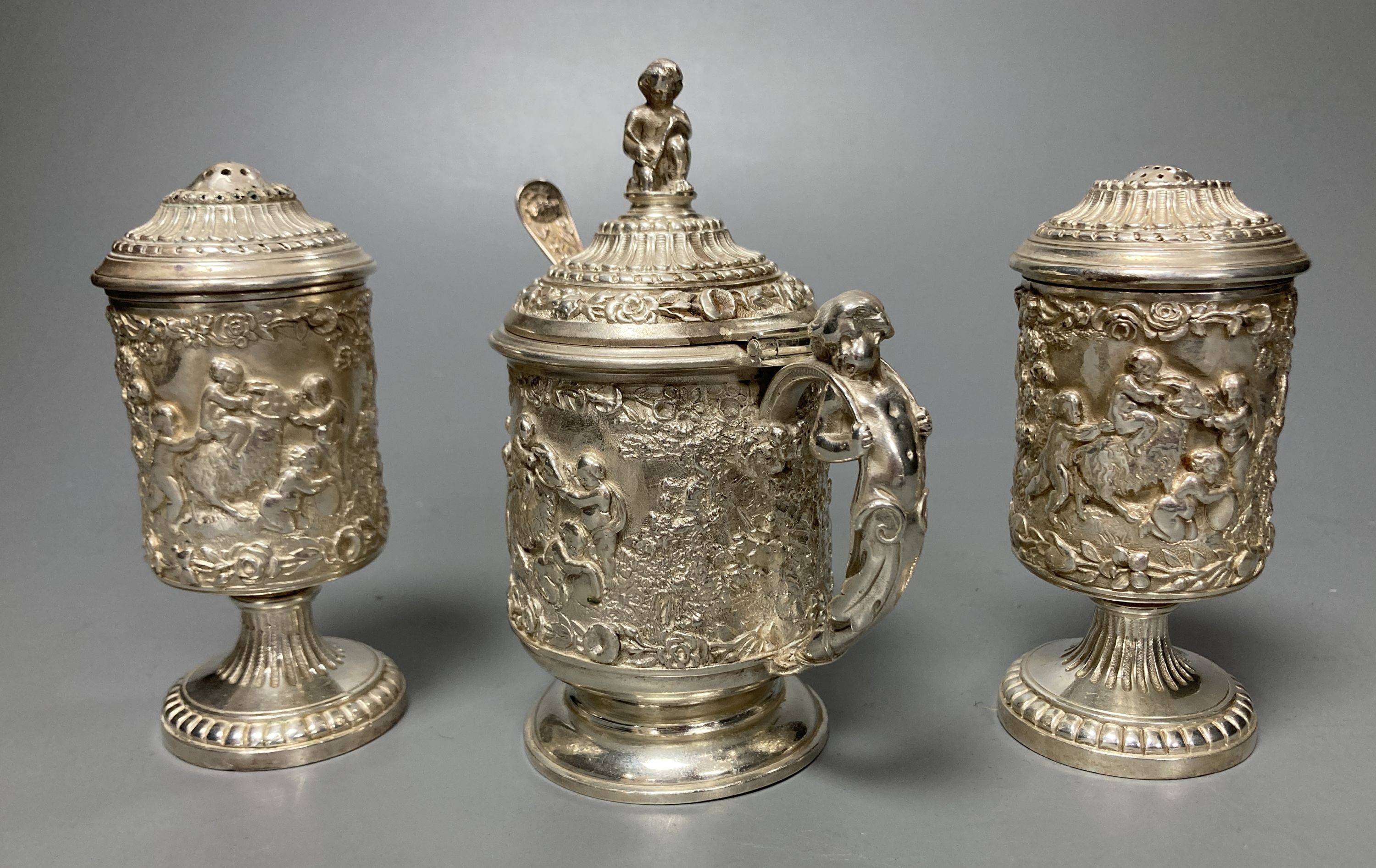 A three piece silver plated cruet set, by Elkington and co-, mustard pot and cover 11.5 cm high                                                                                                                             