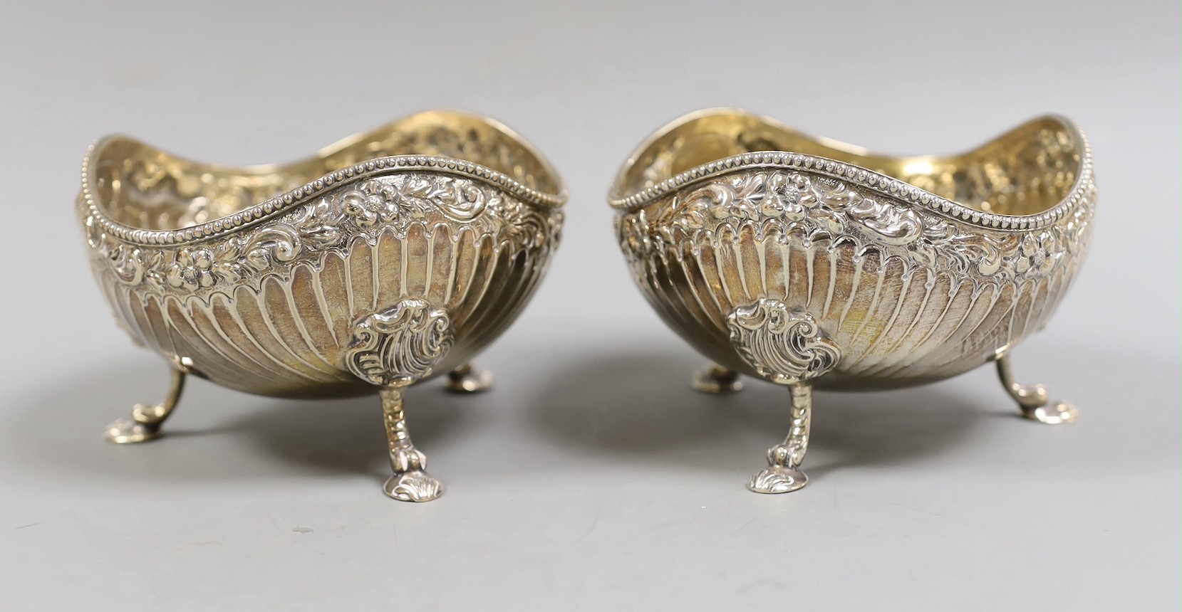 A pair of late Victorian fluted silver sweetmeat bowls, on tripod supports, Daniel & John Welby, London, 1885, diameter 10.7cm, 12.1oz.                                                                                     