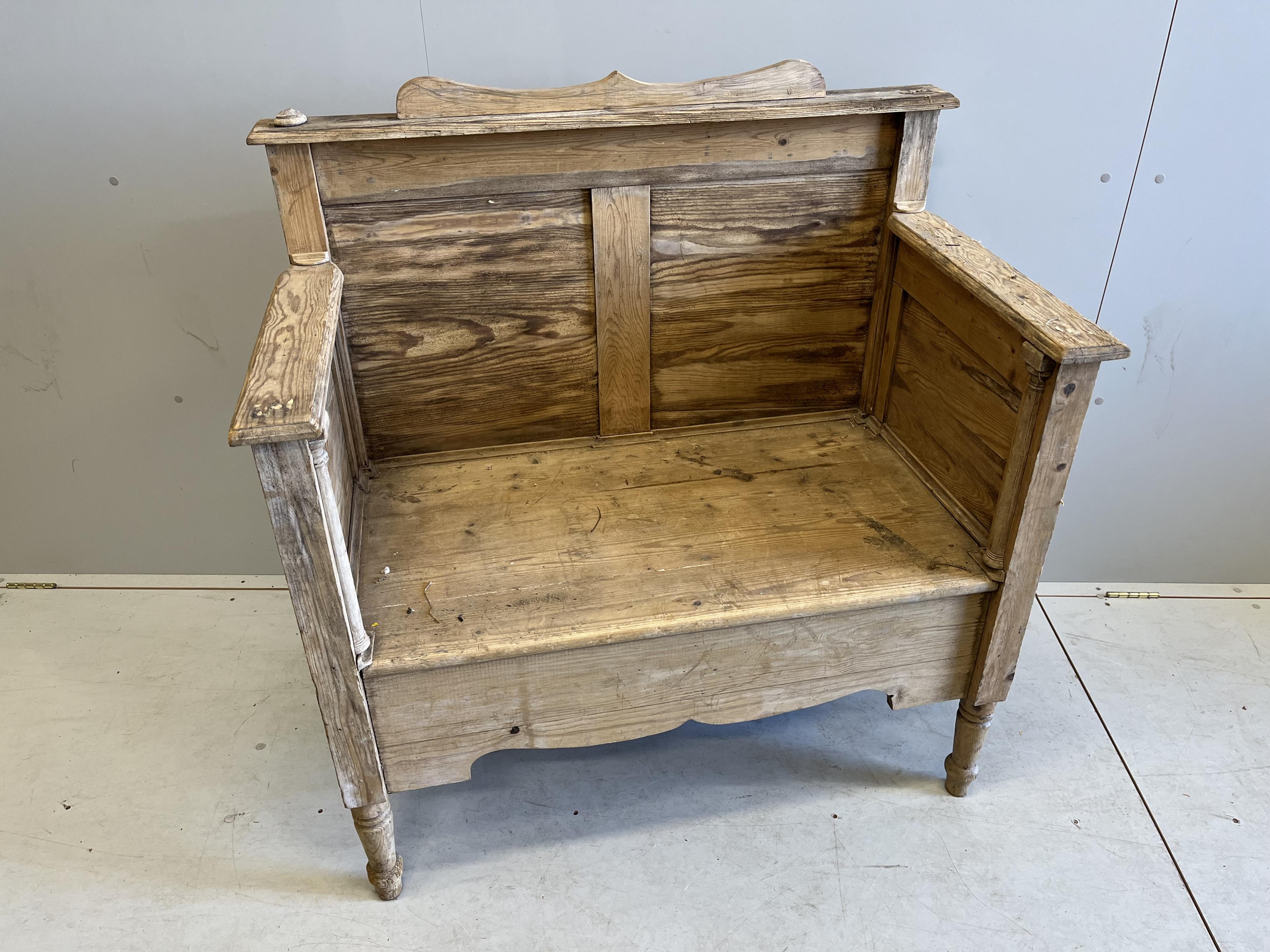 A Victorian style panelled pine settle, width 105cm, depth 60cm, height 110cm                                                                                                                                               