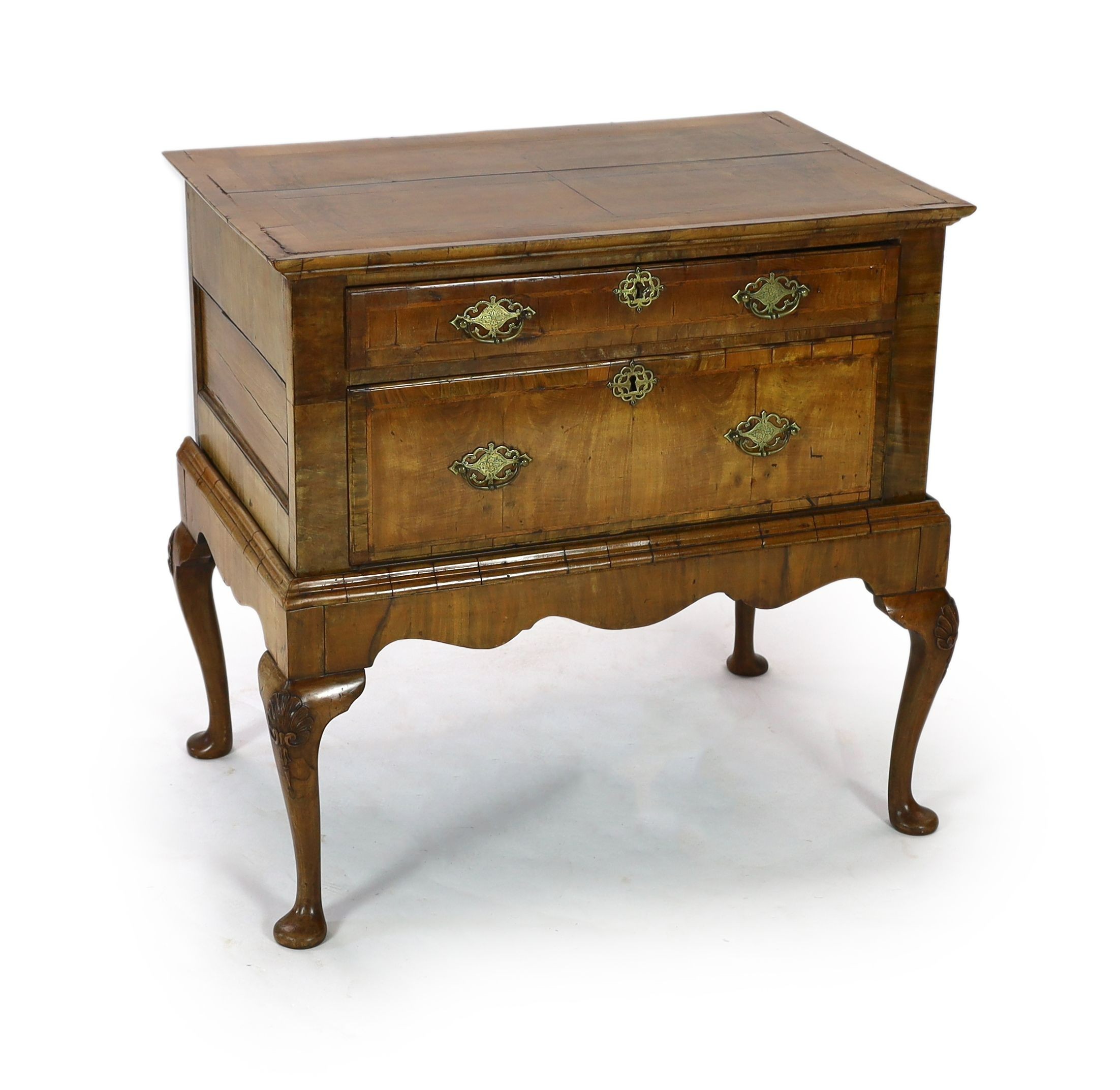 A mid 18th century featherbanded walnut chest on stand, with moulded quarter veneered top, one long and one deep drawer, on stand with shell kneed cabriole legs and pad feet, width 96cm depth 62cm height 93cm            