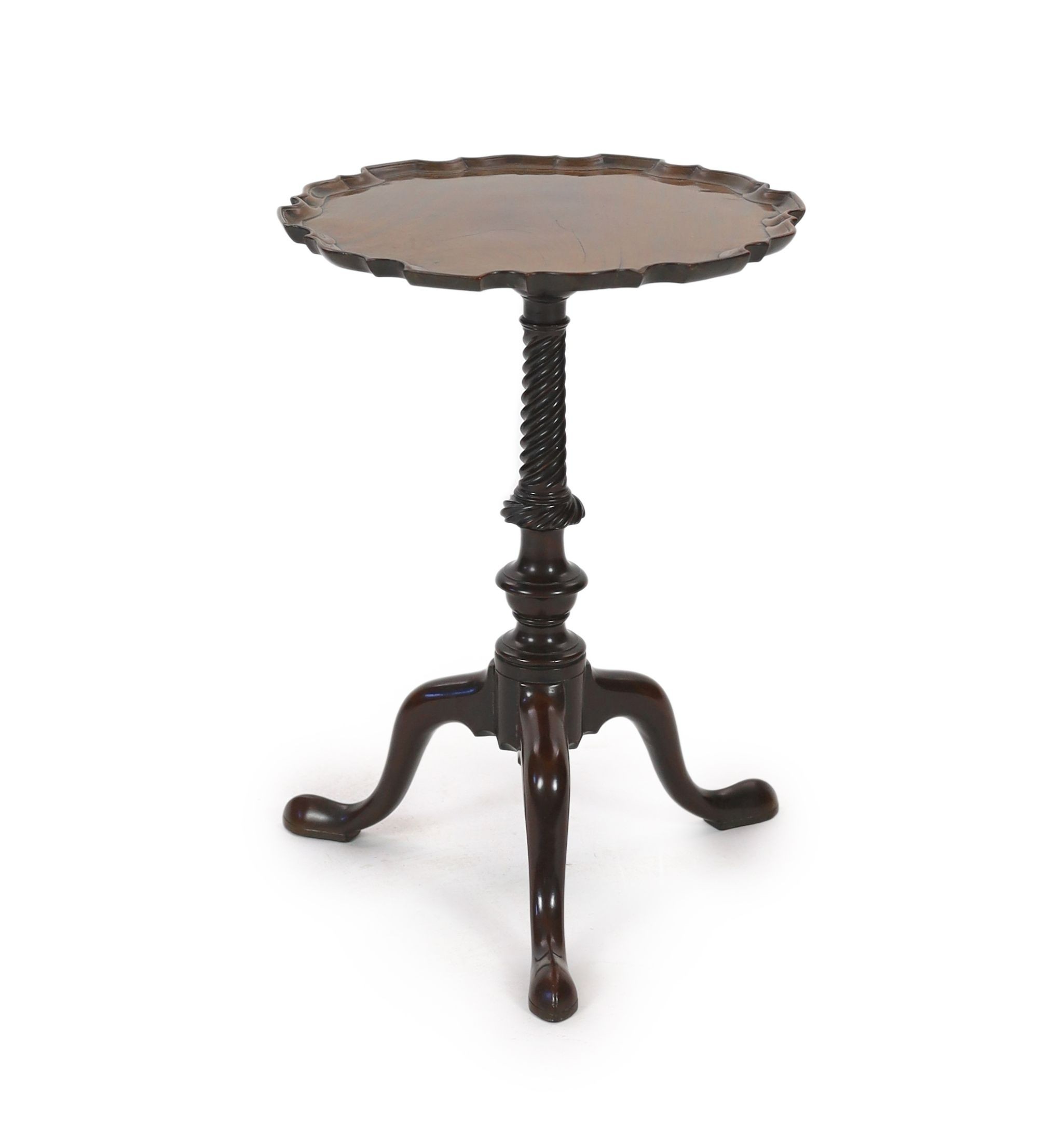 A George III and later mahogany tripod wine table, with circular piecrust top and spiral fluted stem on cabriole tripod base with pointed pad feet, diameter 38cm height 52cm                                               
