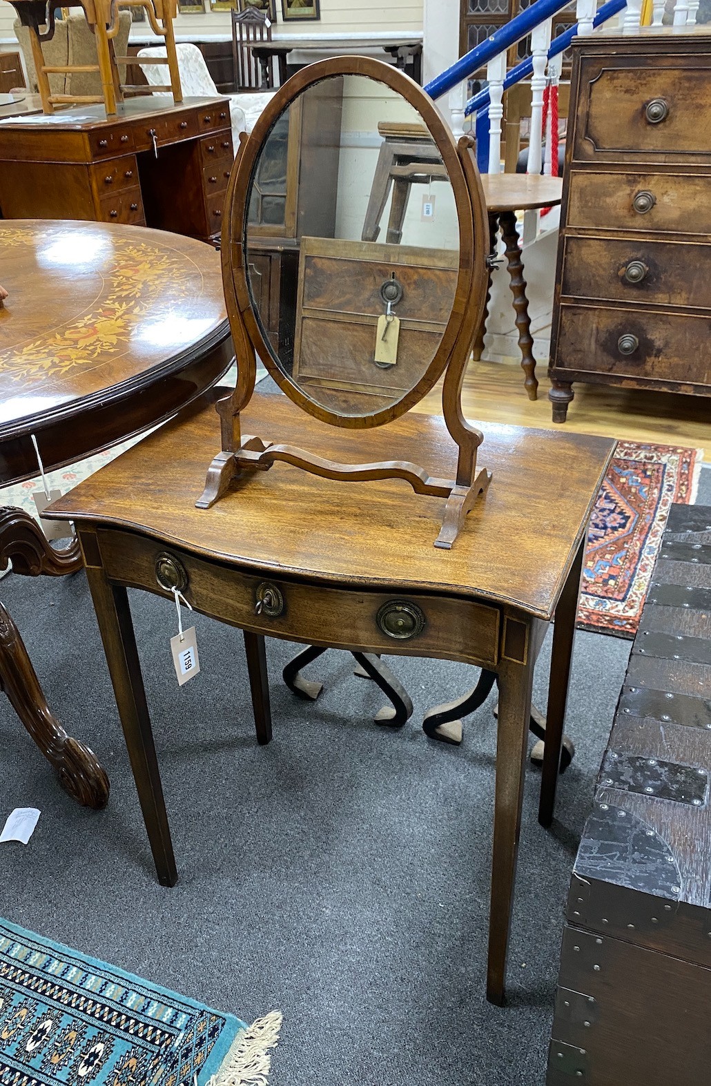 A George III-style serpentine mahogany side table, width 60cm, depth 42cm, height 71cm and a skeleton framed toilet mirror                                                                                                  