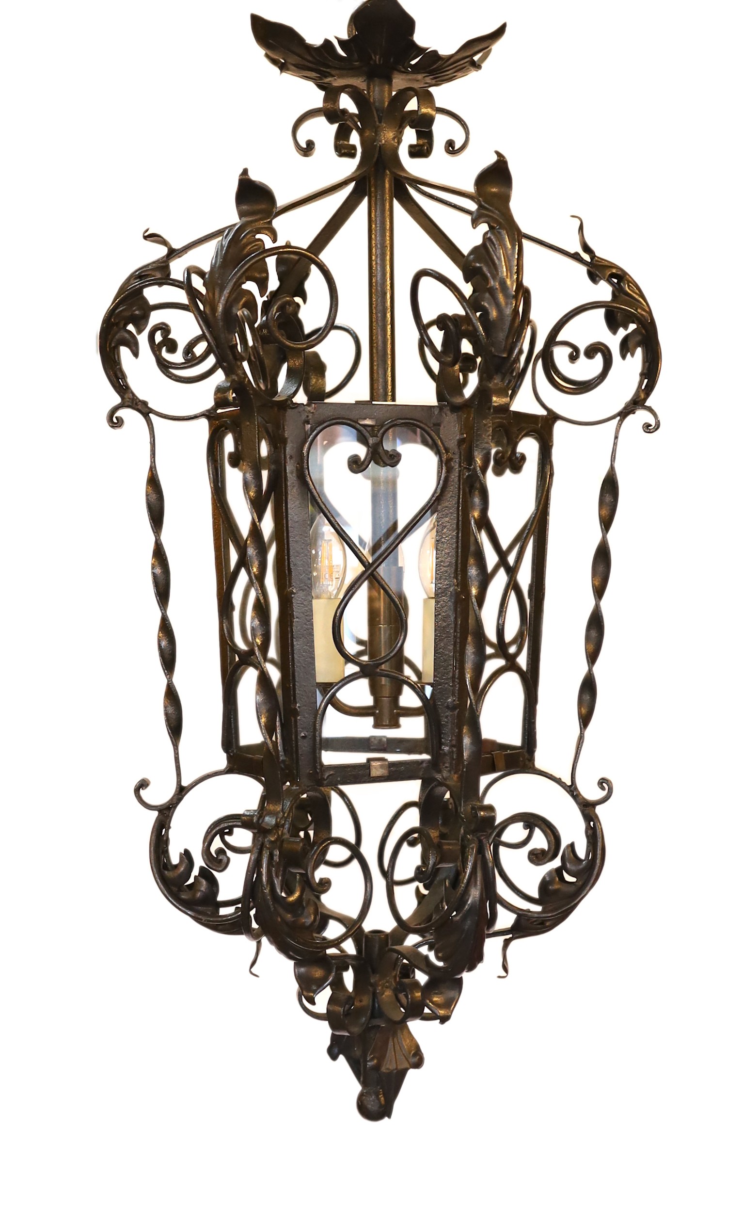 An early 20th century English black painted wrought iron hexagonal hall lantern, drop 92cm. width 42cm                                                                                                                      