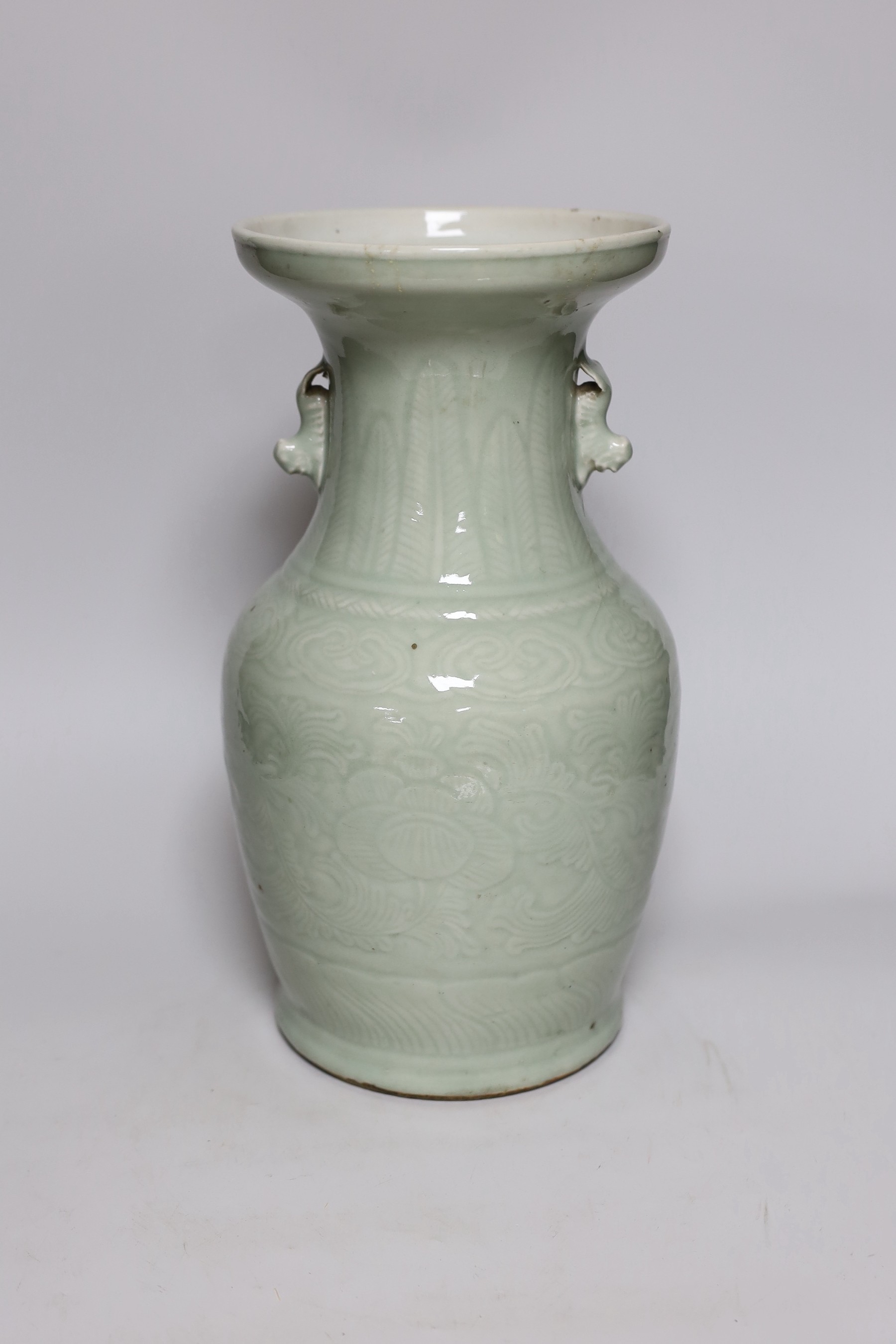 A Chinese celadon glazed vase, 19th century, 33cms high                                                                                                                                                                     