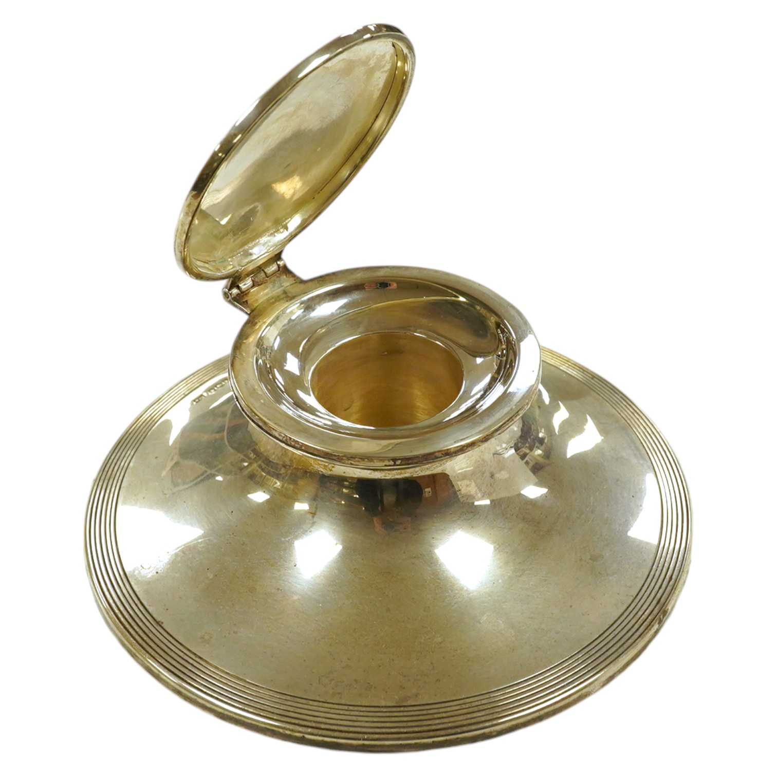 A George V reeded silver capstan inkwell with loaded base, 15cm diameter. Condition - good                                                                                                                                  