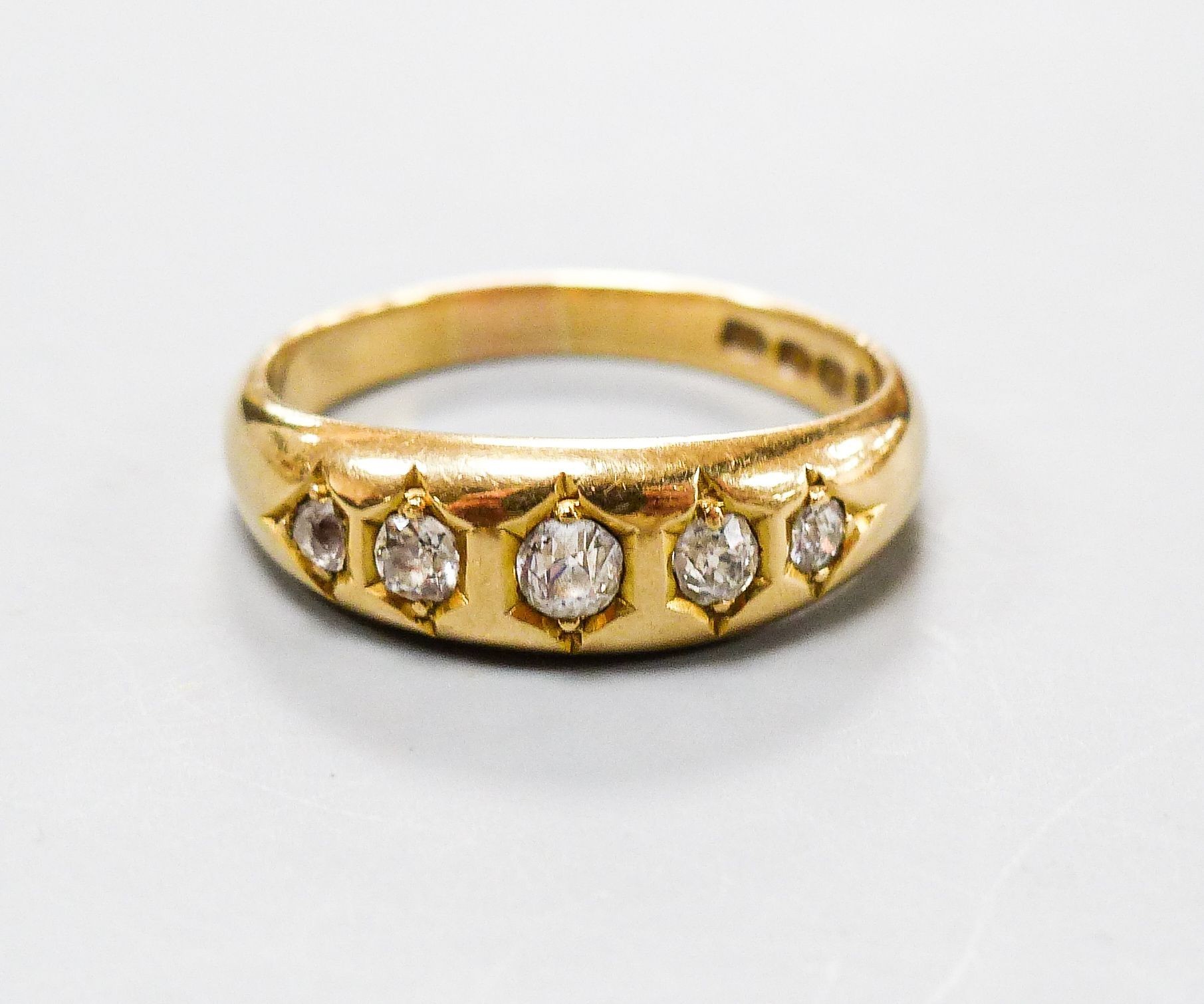 A late Victorian 18ct gold and graduated five stone gypsy set five stone ring, size Q, gross weight 5.5 grams.                                                                                                              