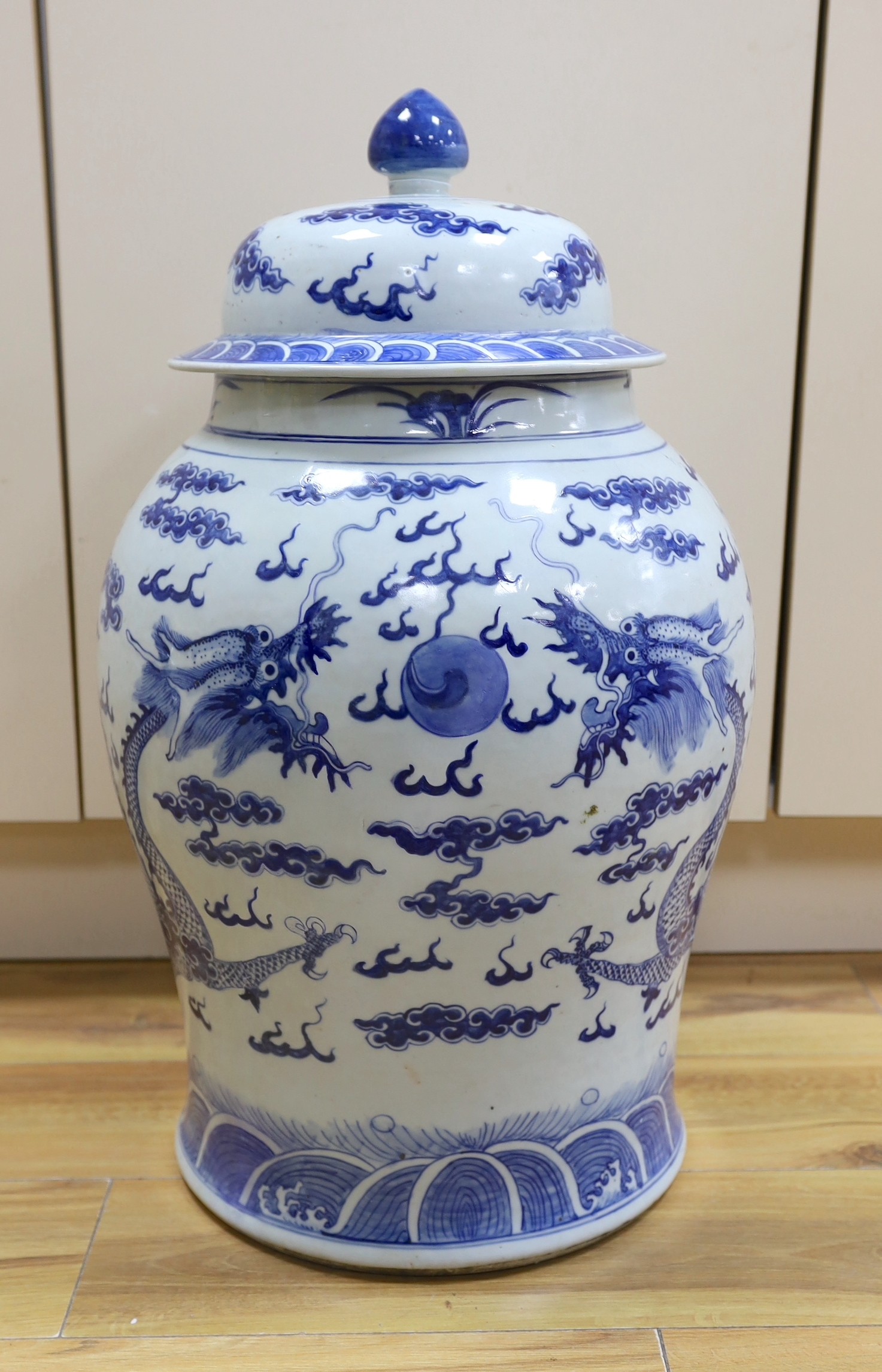A 19th century Chinese large blue and white 'dragon' jar and cover, 63cms high                                                                                                                                              