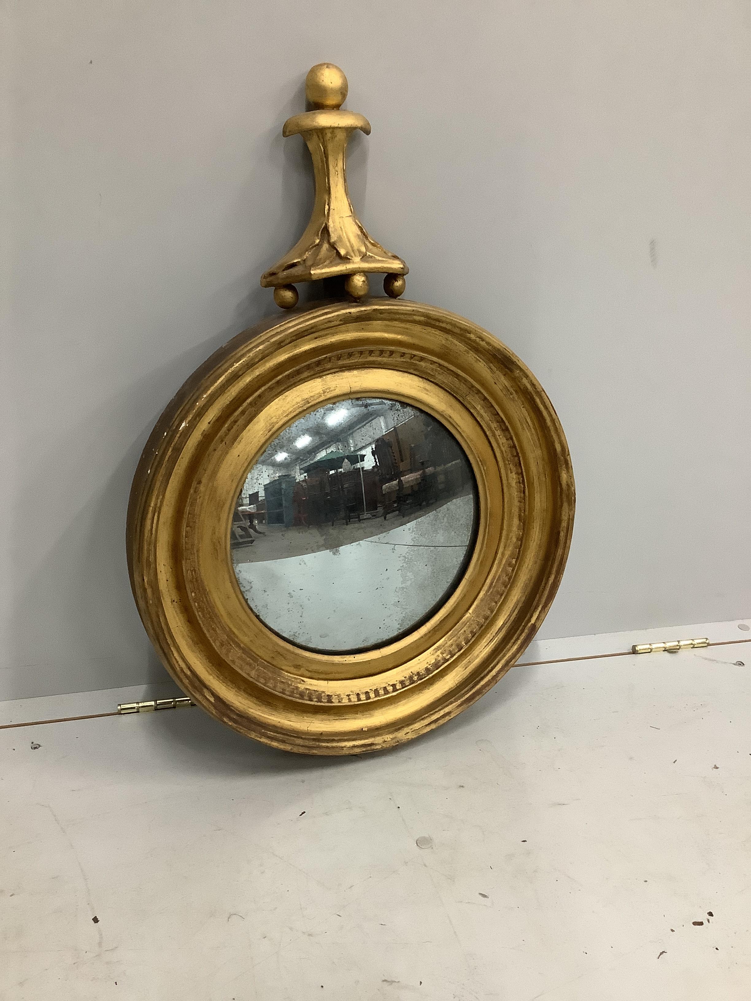A Regency giltwood and composition convex mirror, diameter 50cm, height 71cm                                                                                                                                                