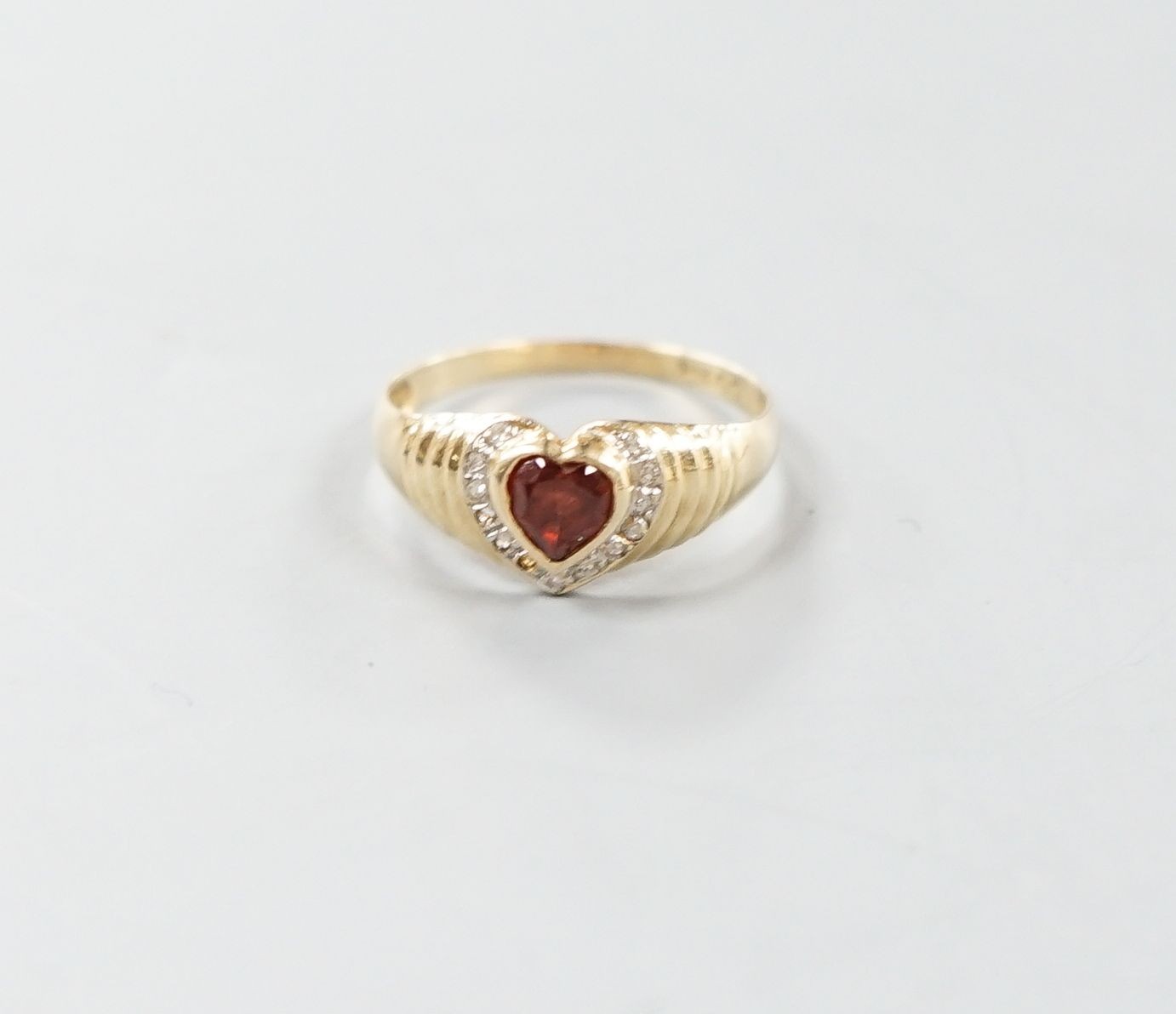 A 14k, hearts shaped paste and diamond chip set dress ring, size N/O, gross weight 2.1 grams.                                                                                                                               