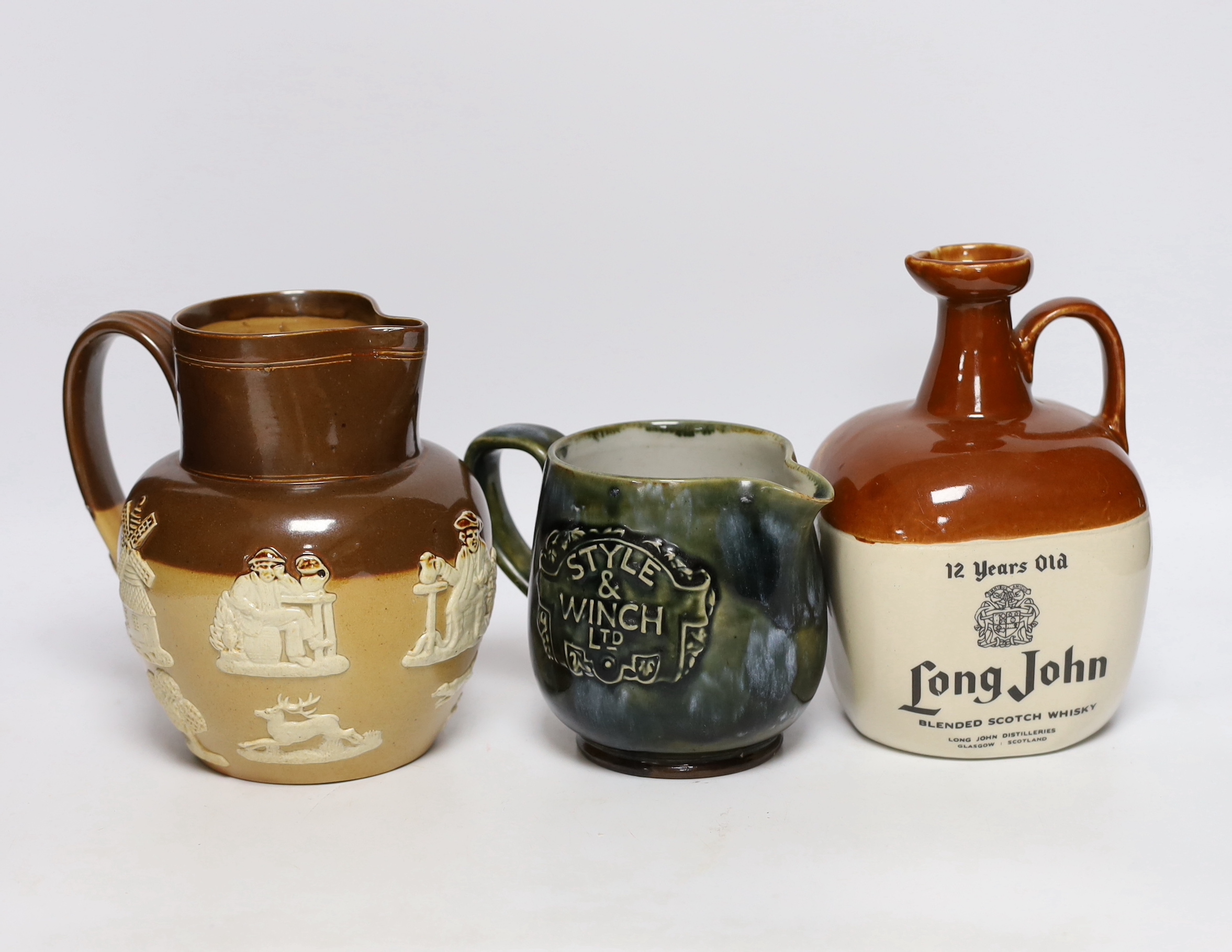 Two Doulton stoneware jugs and a Long John whisky ewer, largest 17cm high                                                                                                                                                   