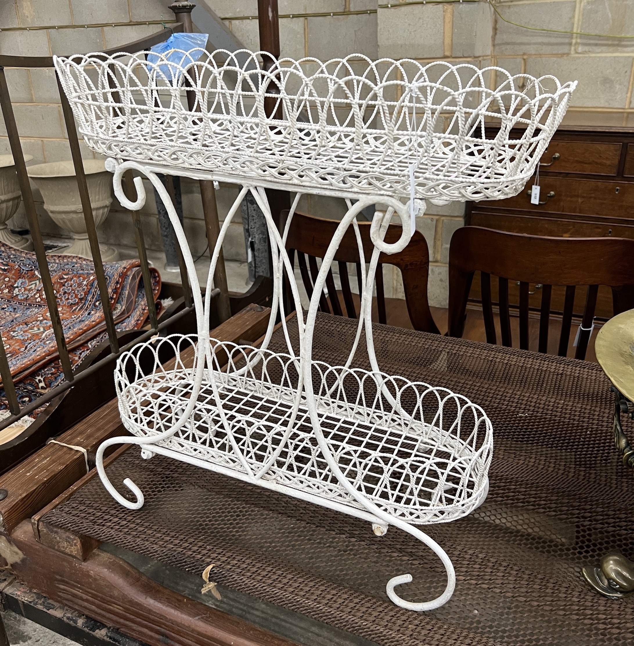 A painted wrought metal two tier pot stand, width 67cm, depth 27cm, height 70cm                                                                                                                                             