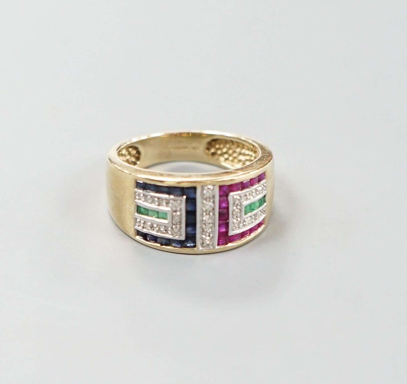 A modern 9ct gold, emerald, ruby, sapphire and diamond set geometric dress ring, size Q, gross weight 5.3 grams.                                                                                                            