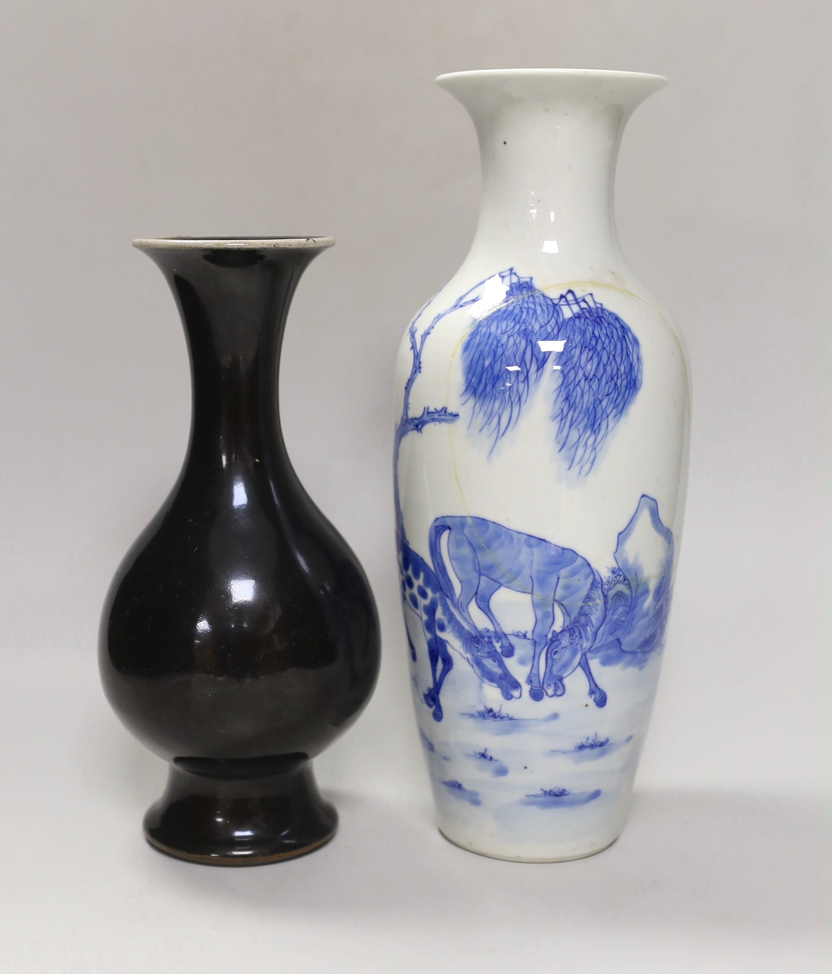A Chinese mirror-black glazed vase, 18th century and a 19th century Chinese blue and white 'horses' vase, tallest 30cm                                                                                                      