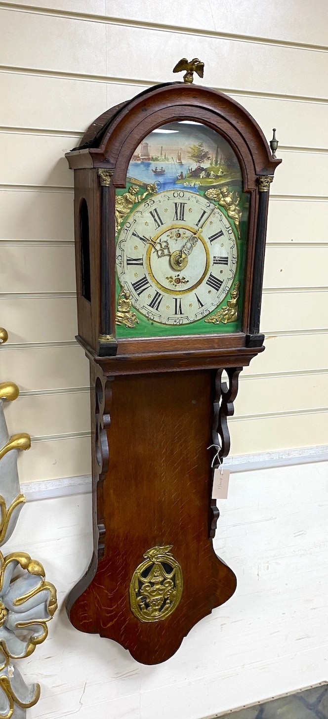 A Dutch oak wall clock with arched painted dial, height 130cm                                                                                                                                                               