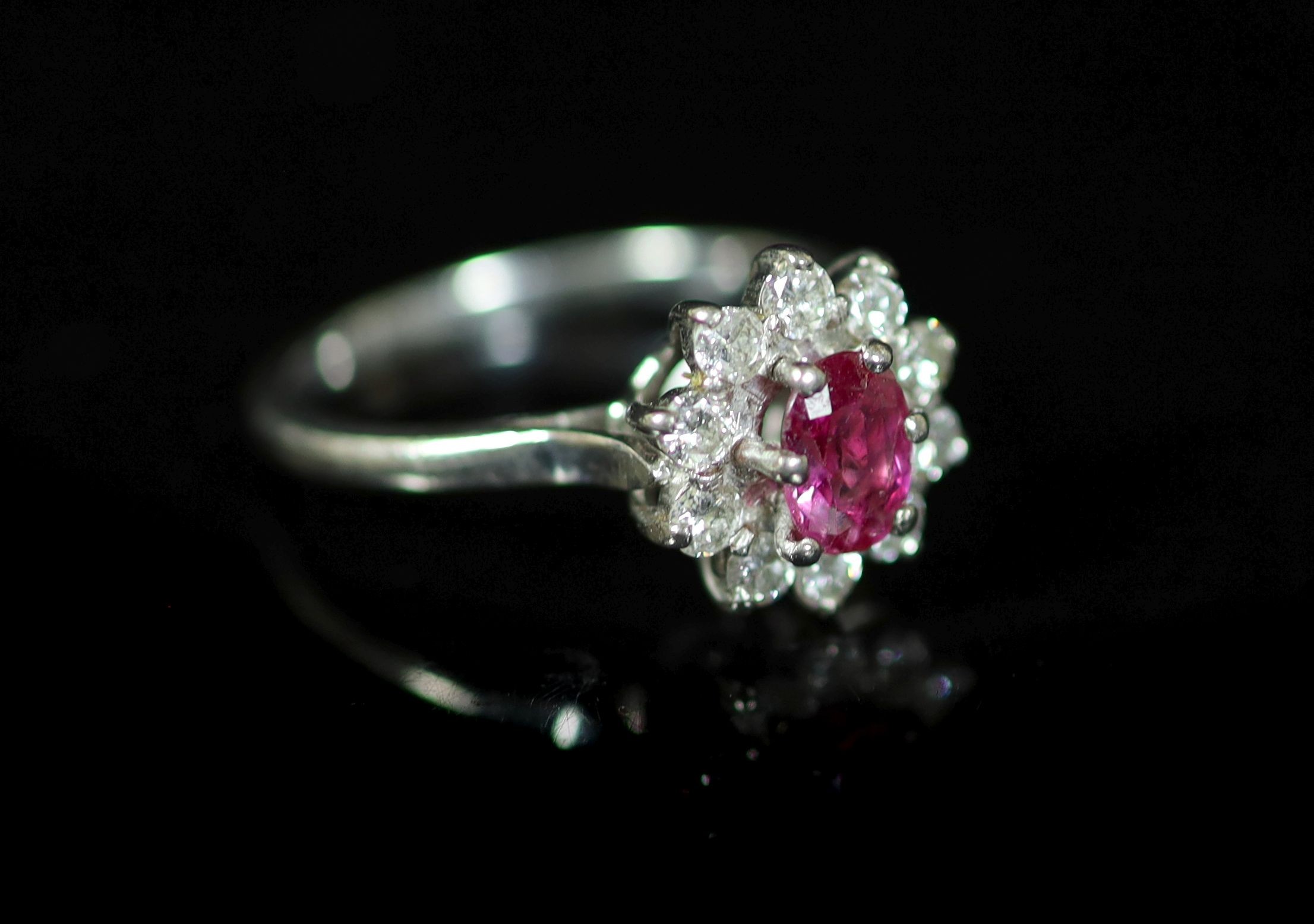 A white gold, ruby and diamond set flower head cluster ring                                                                                                                                                                 