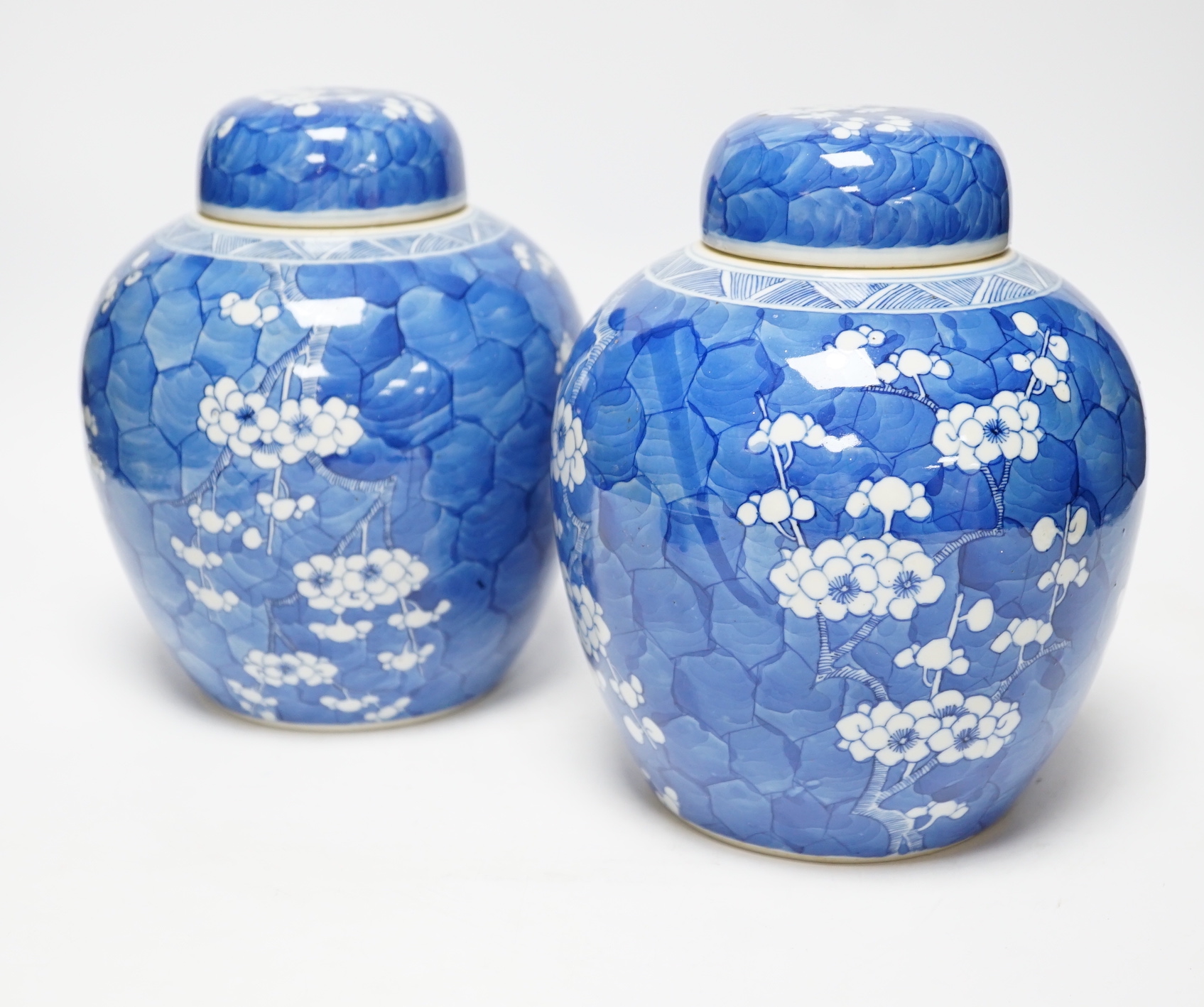 A pair of Chinese blue and white prunus jars and covers, late 19th century, 21.5cm                                                                                                                                          