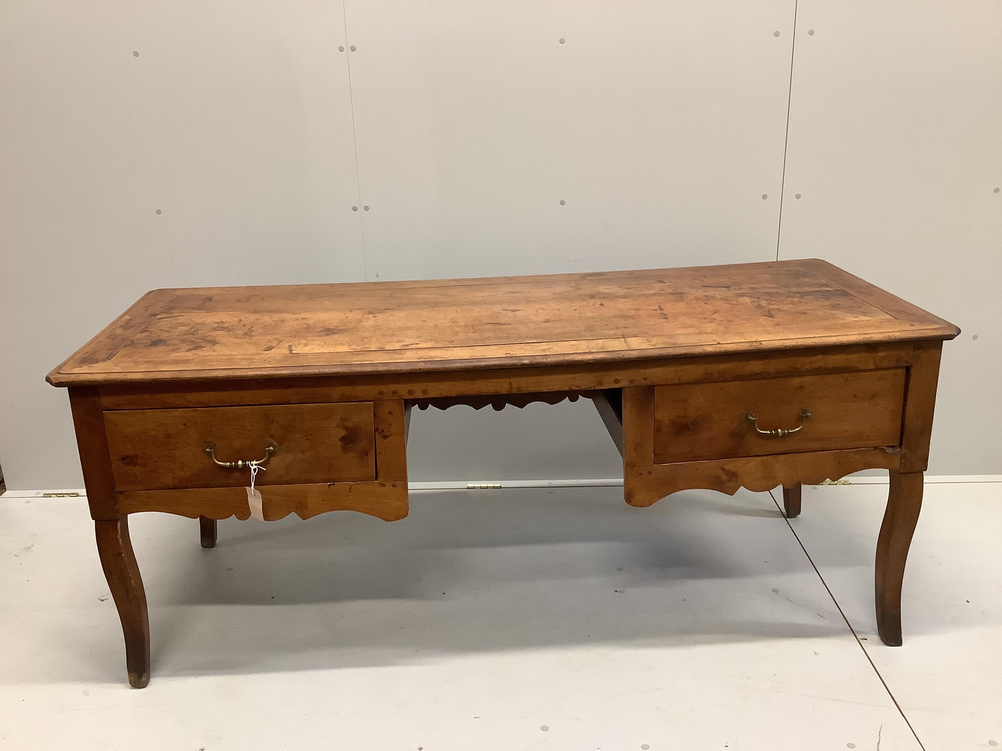 A late 18th century French Provincial fruitwood kneehole table, width 178cm, depth 70cm, height 74cm                                                                                                                        