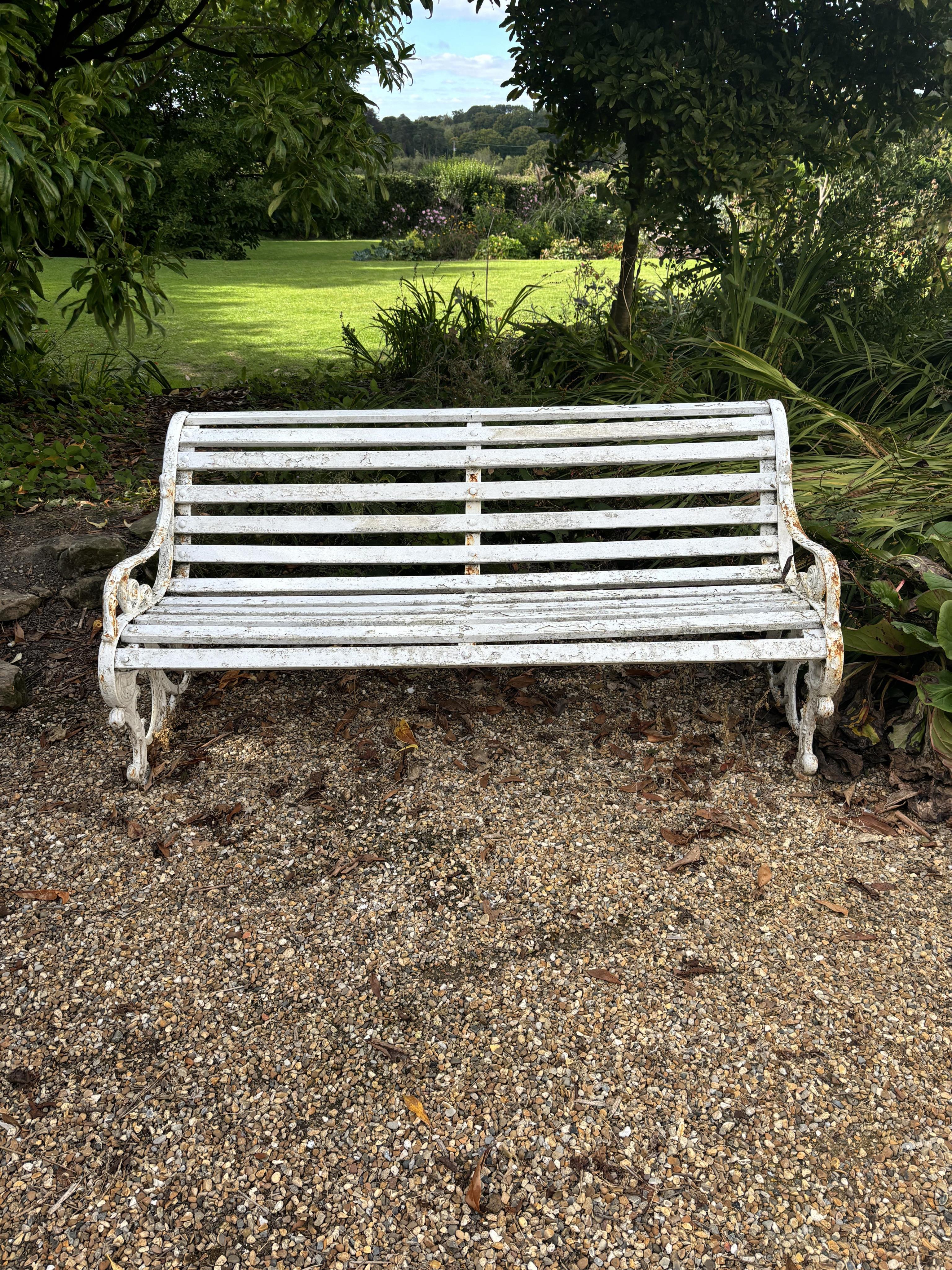 A white painted wrought iron and wood slatted garden bench, 163cm. Condition - weathered, otherwise solid                                                                                                                   