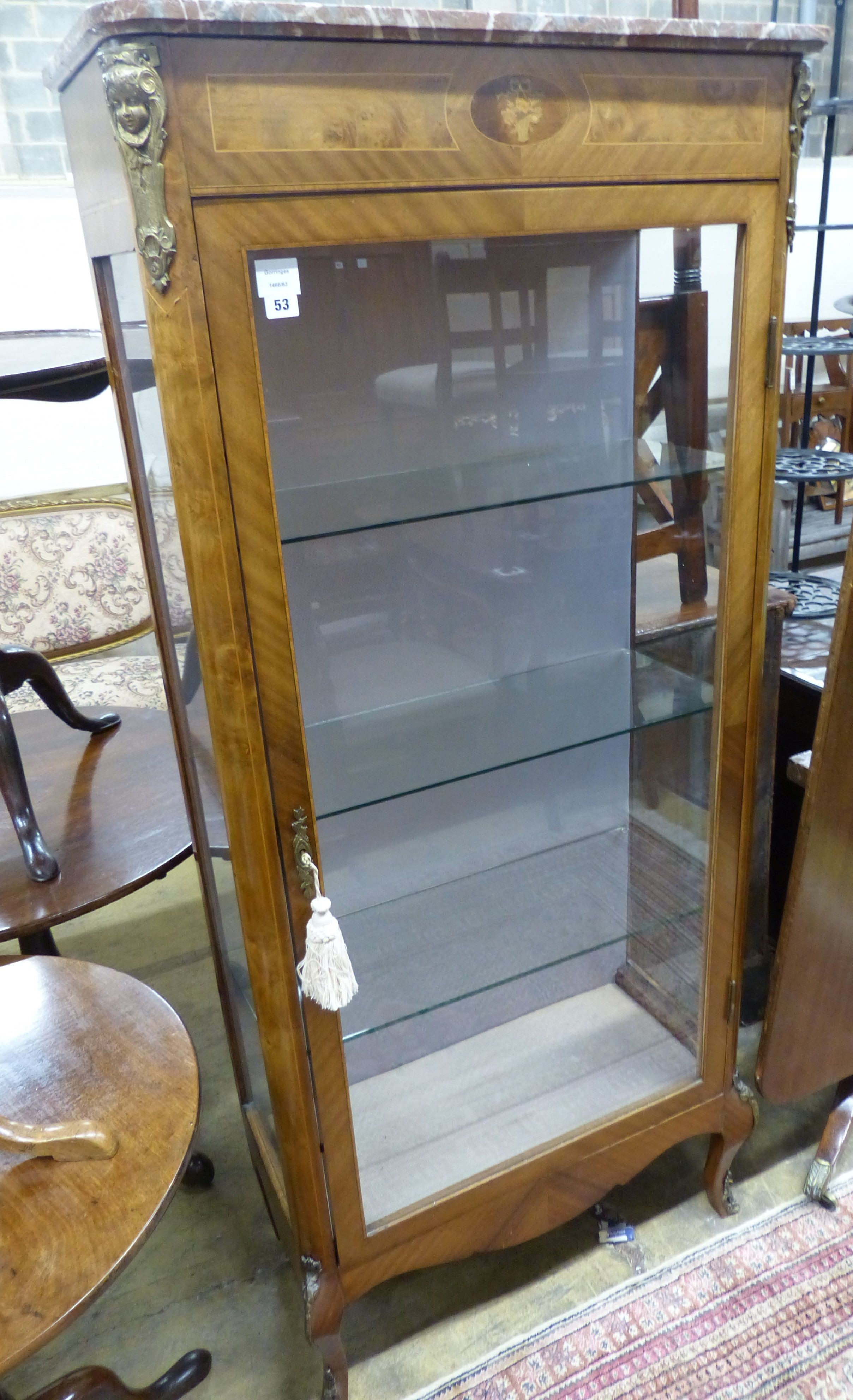 A late 19th century Louis XV style vitrine, with a shaped marble top above a single glazed panelled door, with applied cast metal mounts, W.78cm D.36cm H.175cm                                                             